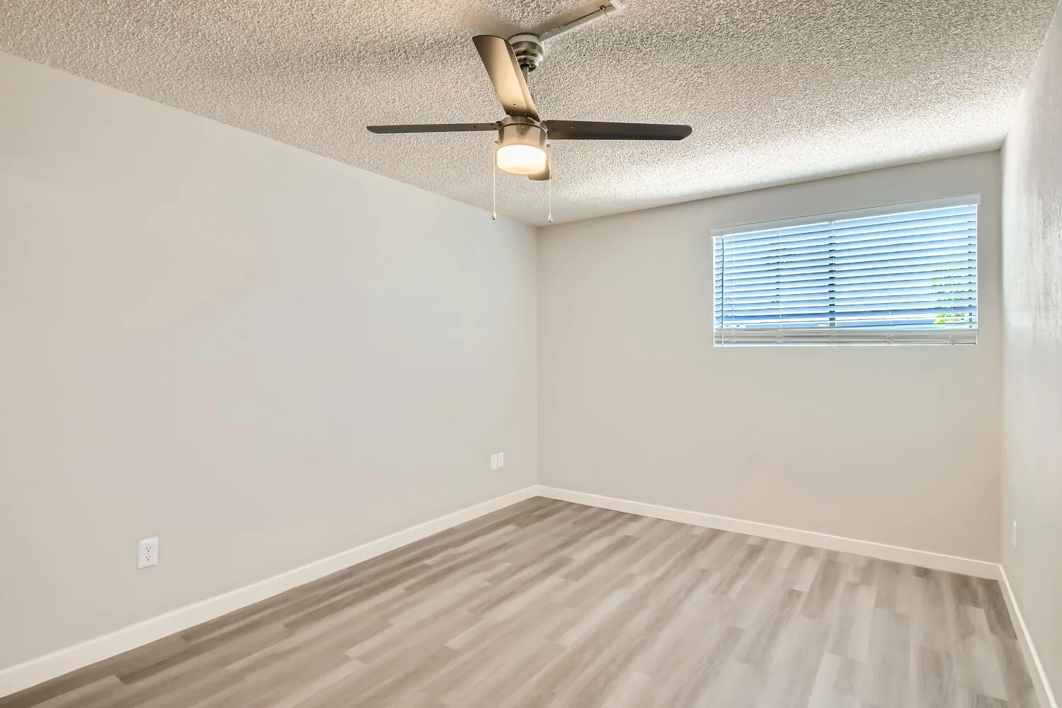 Bedroom, ceiling fan, window with blinds, wood-style plank flooring