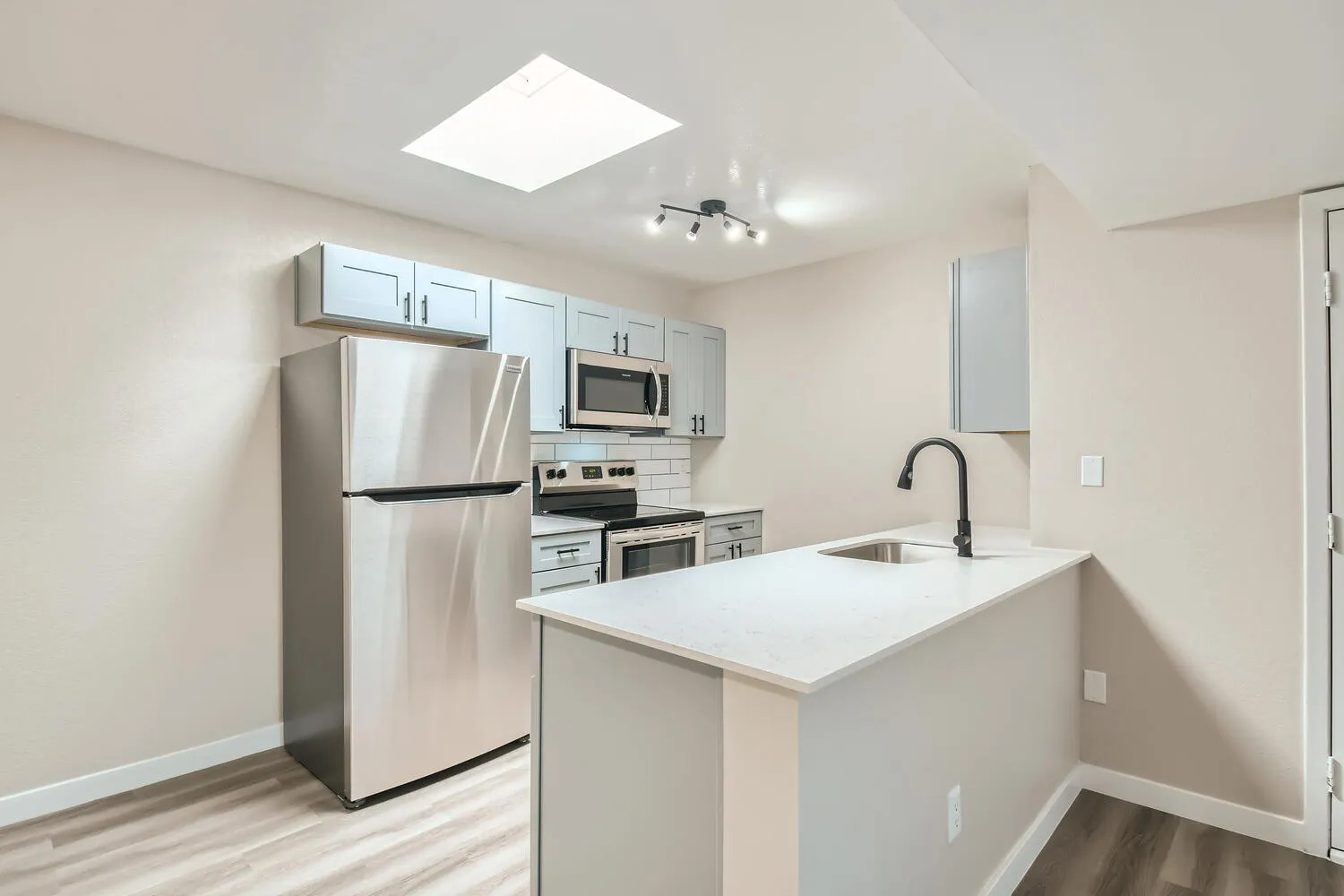 Kitchen, gray shaker cabinets, quartz countertops, stainless steel appliances