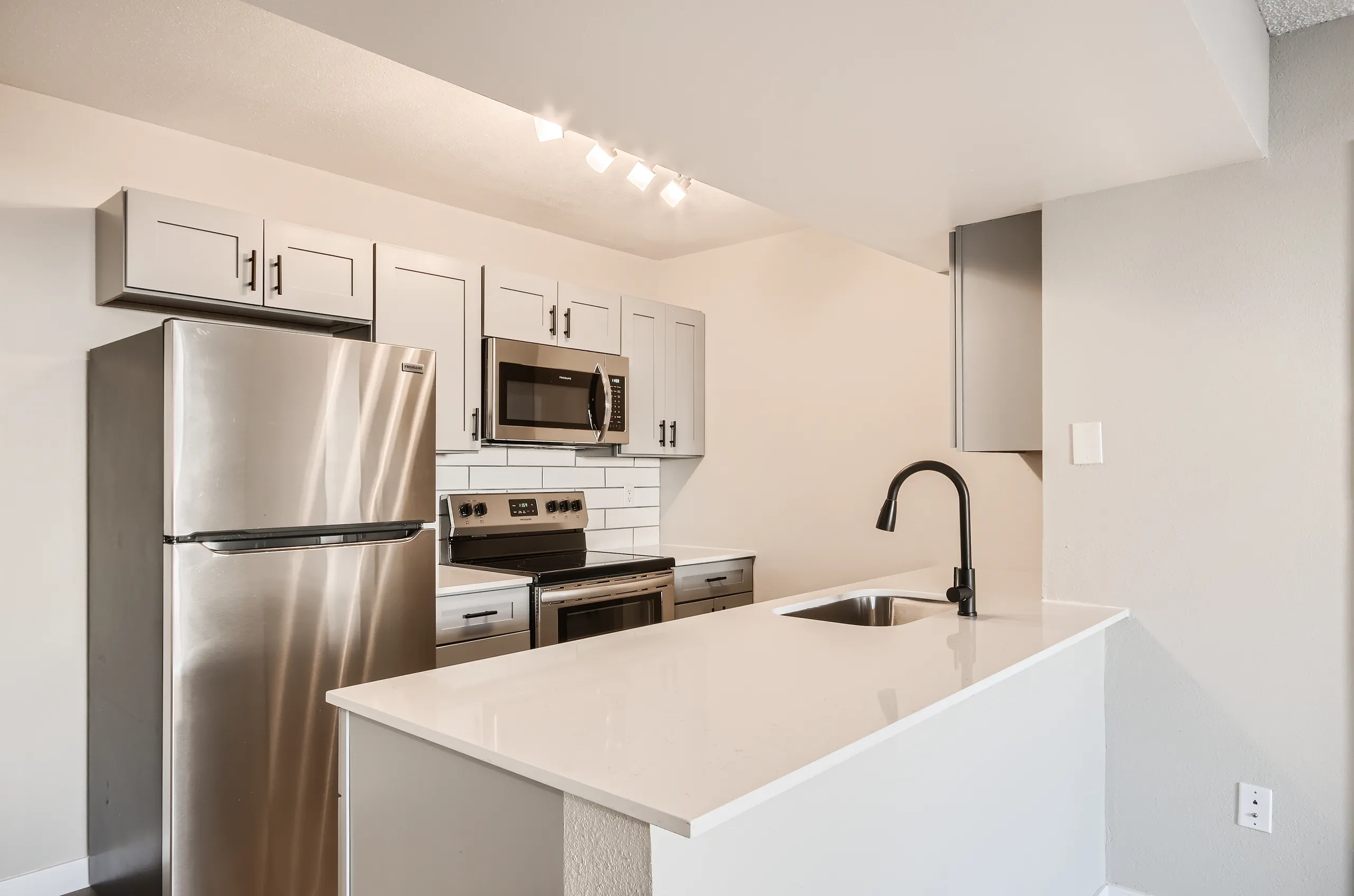 Kitchen, gray shaker cabinets, quartz countertops, stainless steel appliances