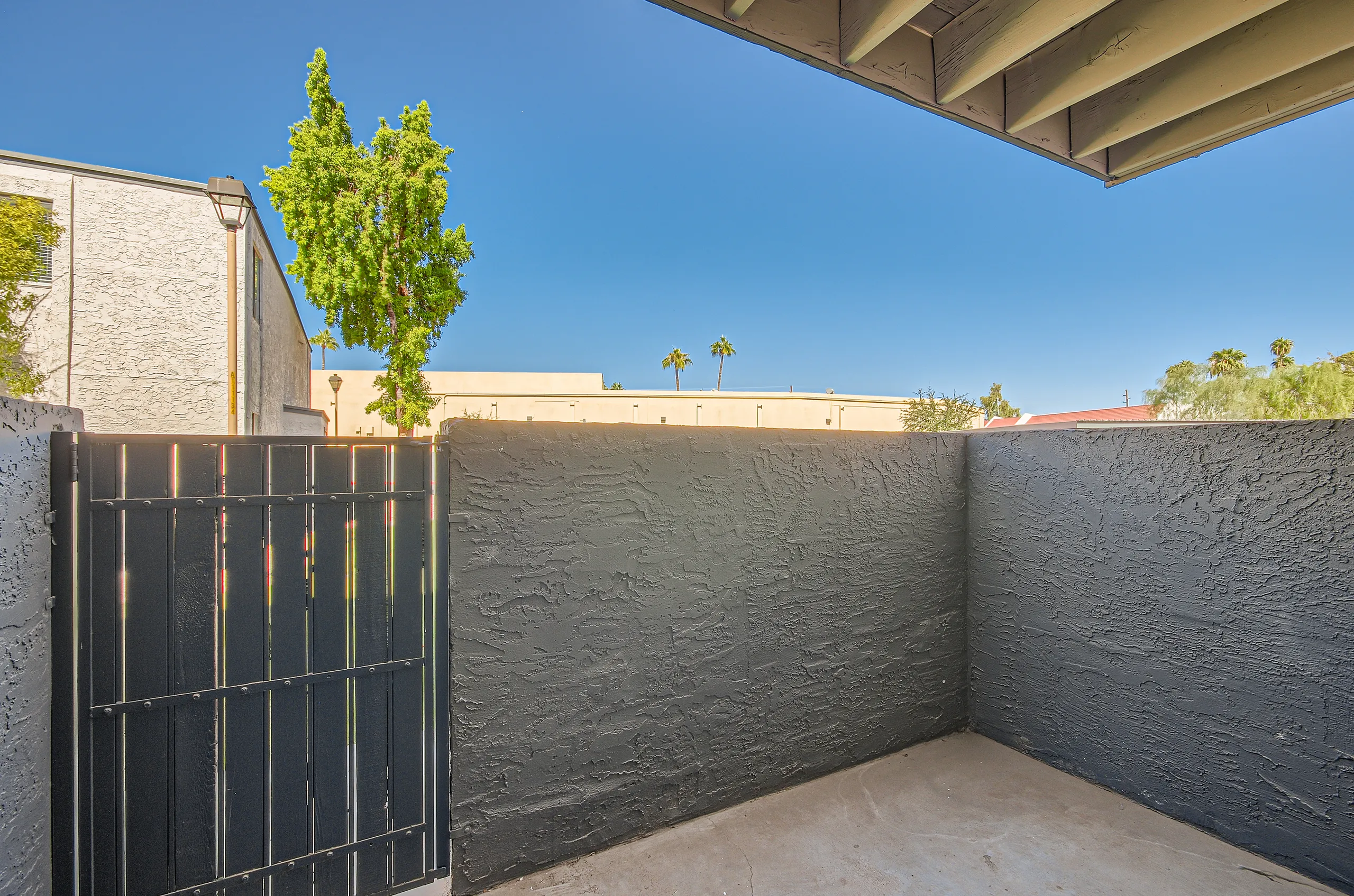 Private patio, gated enclosure, covered overhang