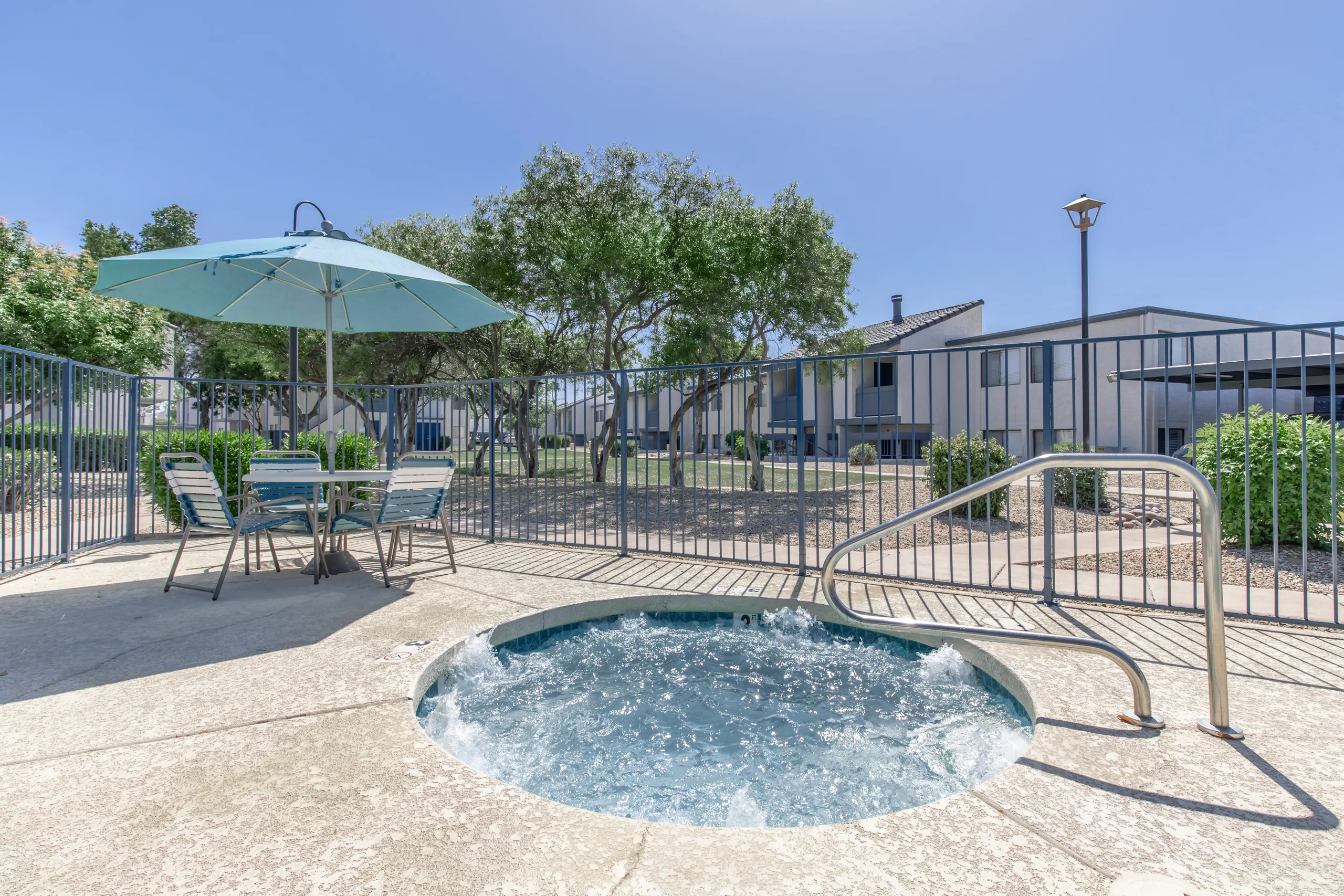 Community spa, umbrella seating area, gated pool deck