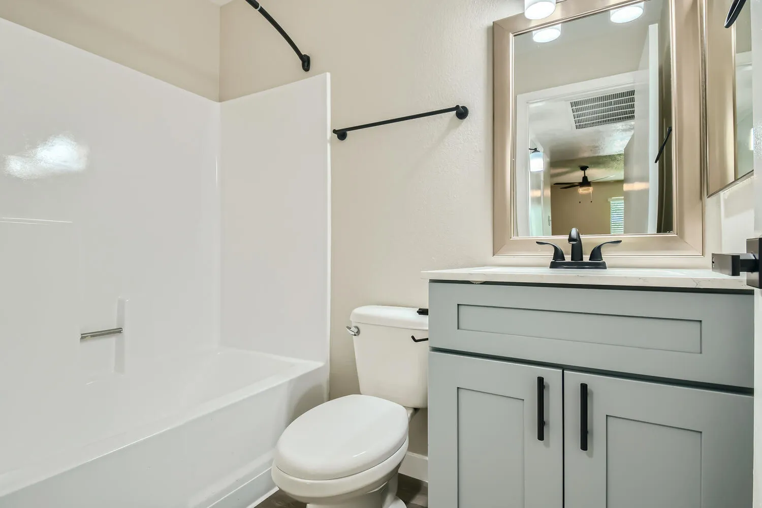 Bathroom, gray vanity cabinet, quartz countertop, tub/shower combo