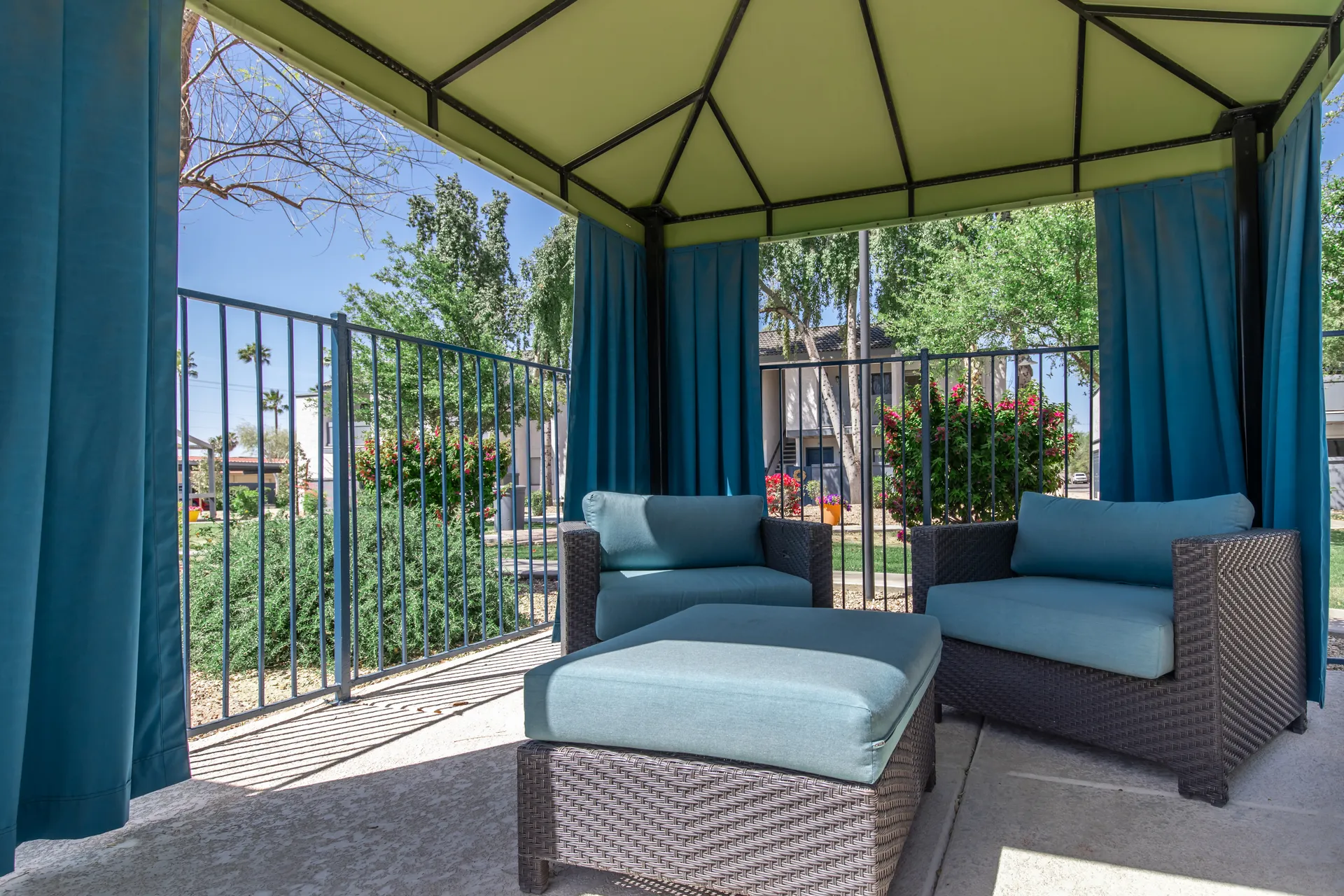 Covered cabana lounge, outdoor seating, poolside landscaping