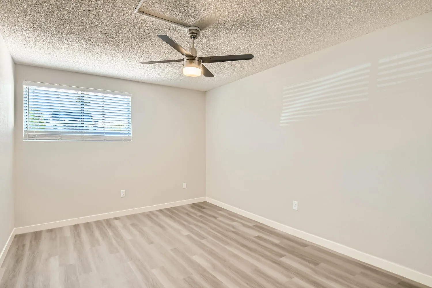 Primary bedroom, ceiling fan, window with blinds