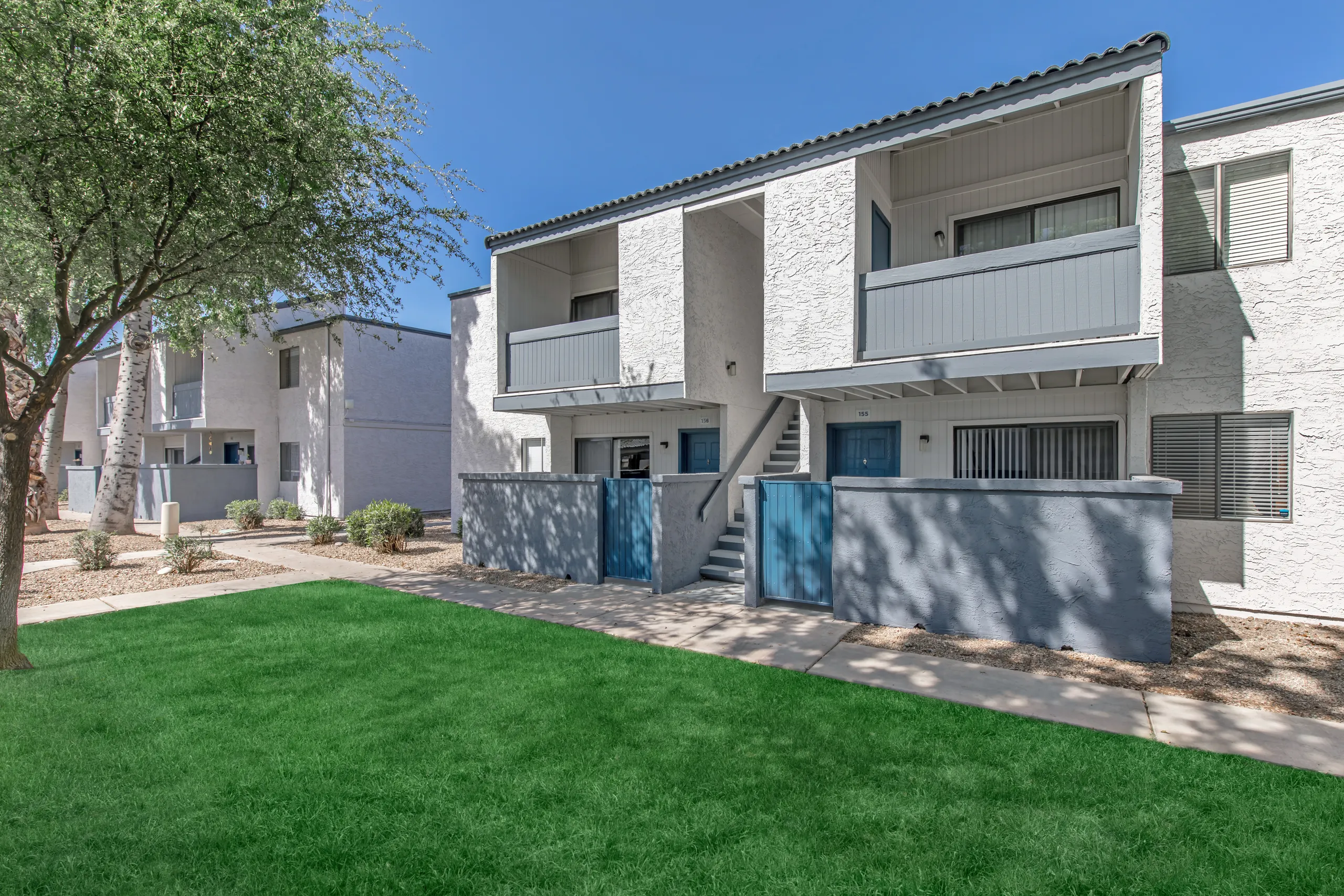 Resident building exterior, private entries, landscaped walkway