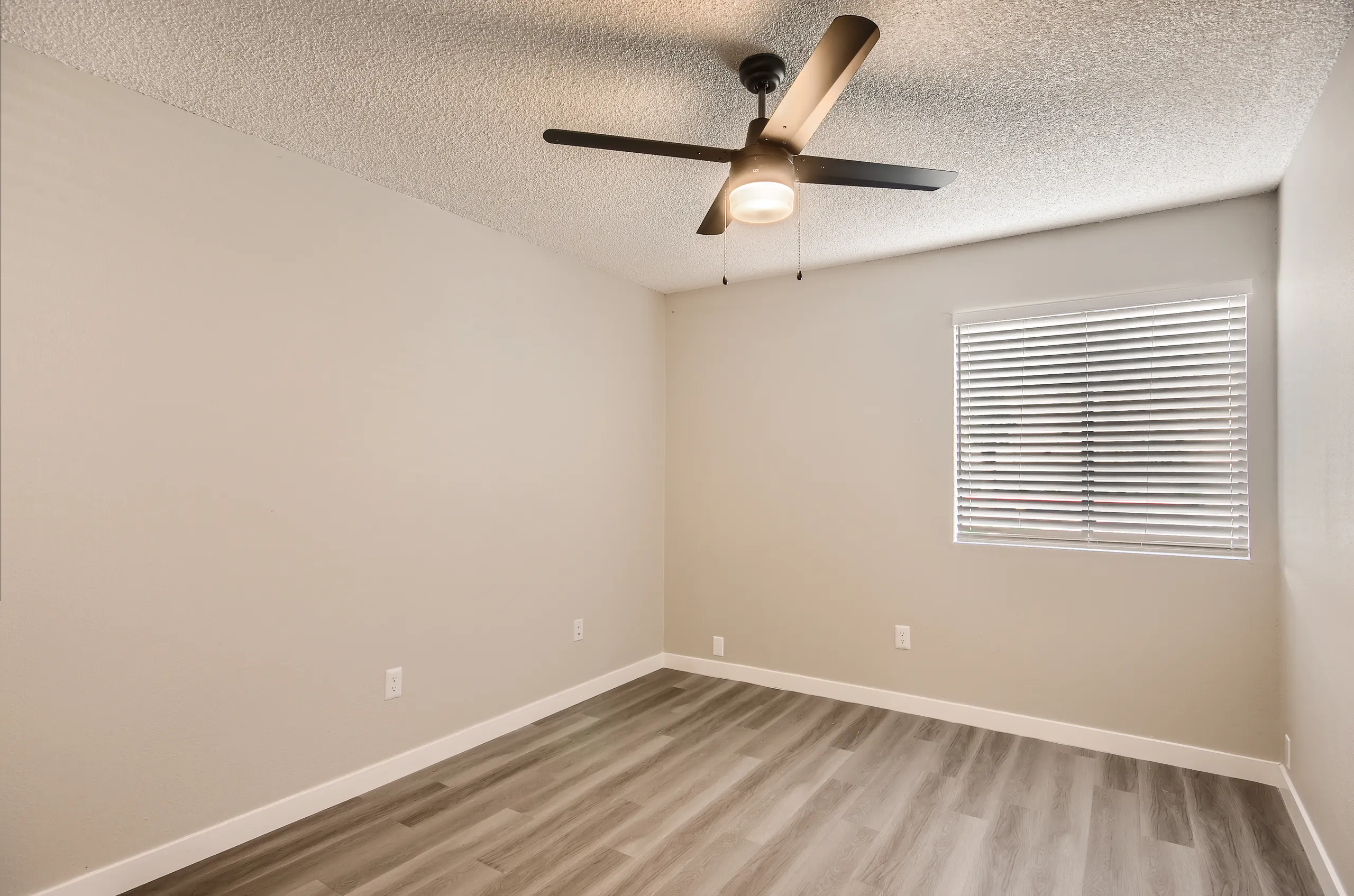 Bedroom, ceiling fan, mini blinds, wood-style plank flooring