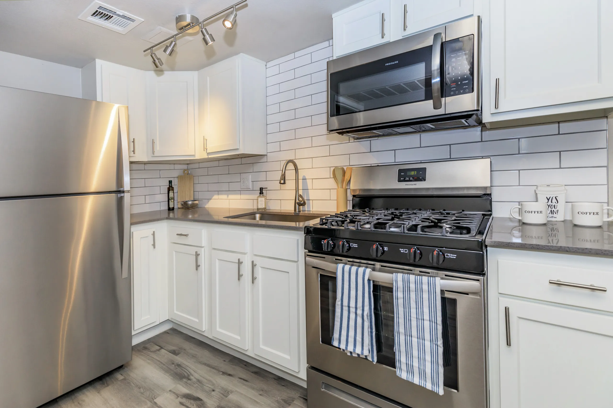 Stainless appliances, subway tile backsplash, granite counters, gas range
