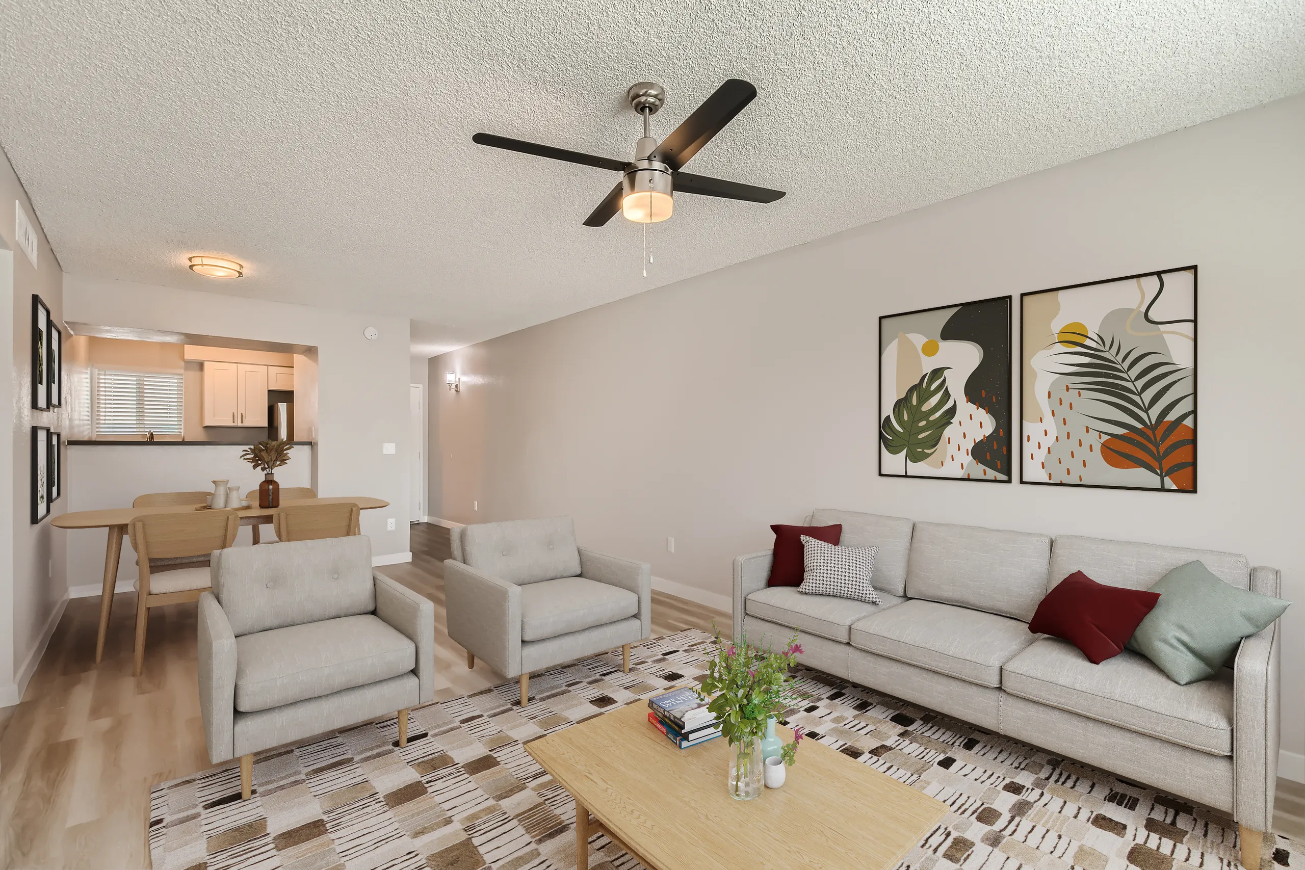 Open living room, view into kitchen, ceiling fan, wood-style plank flooring