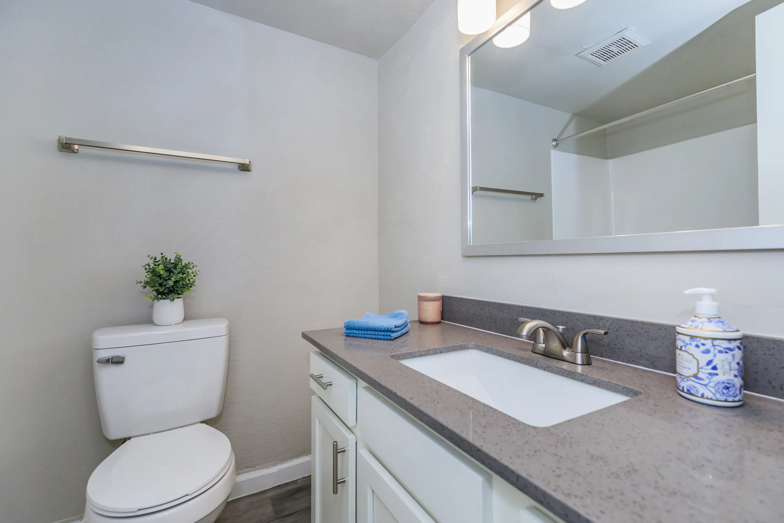 Vanity with granite counter, undermount sink, mirror, towel bar