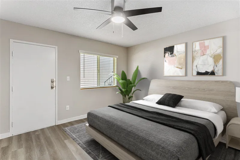 Bedroom/living area, large window, wood-style plank flooring, ceiling fan