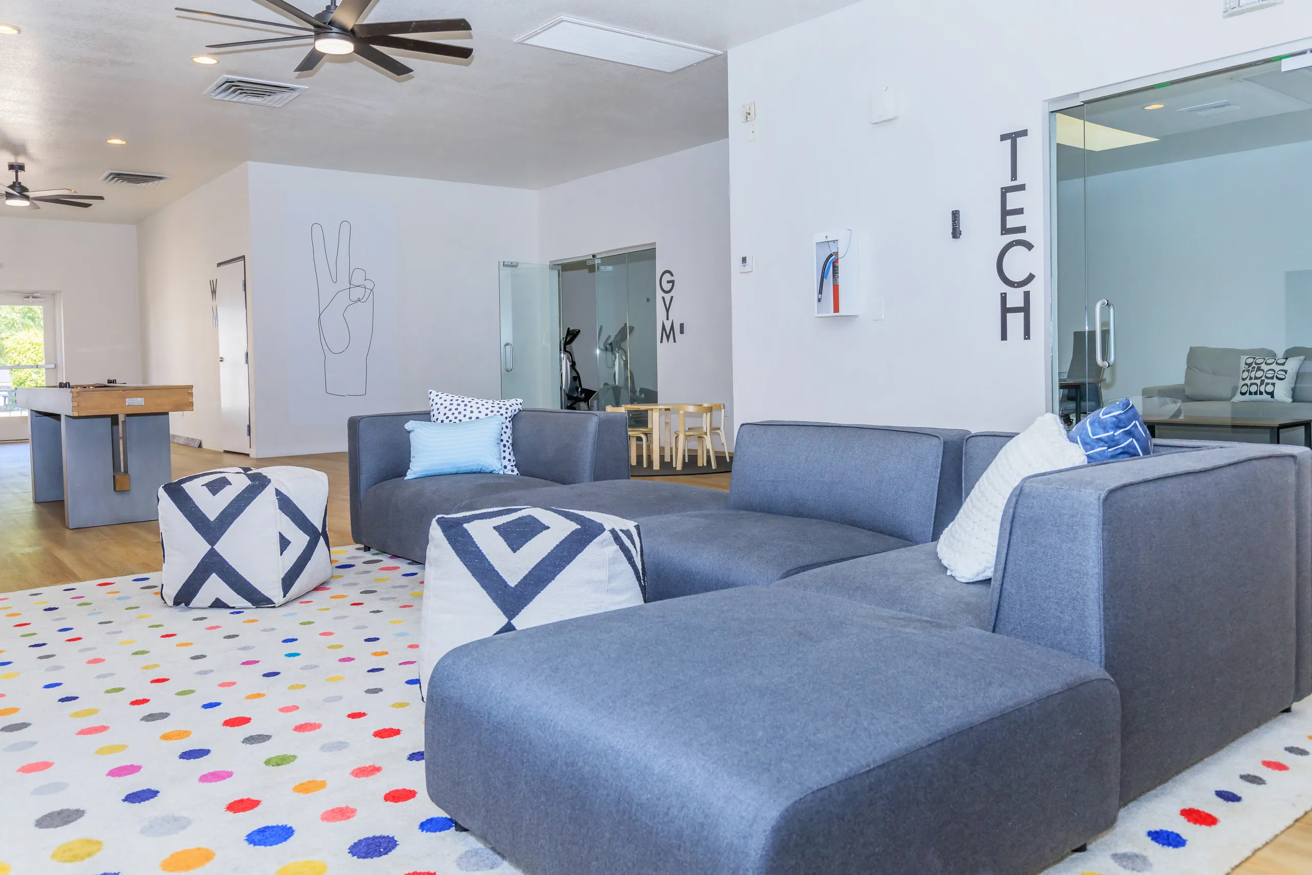 Sectional seating, colorful area rug, game room access, TECH room entry