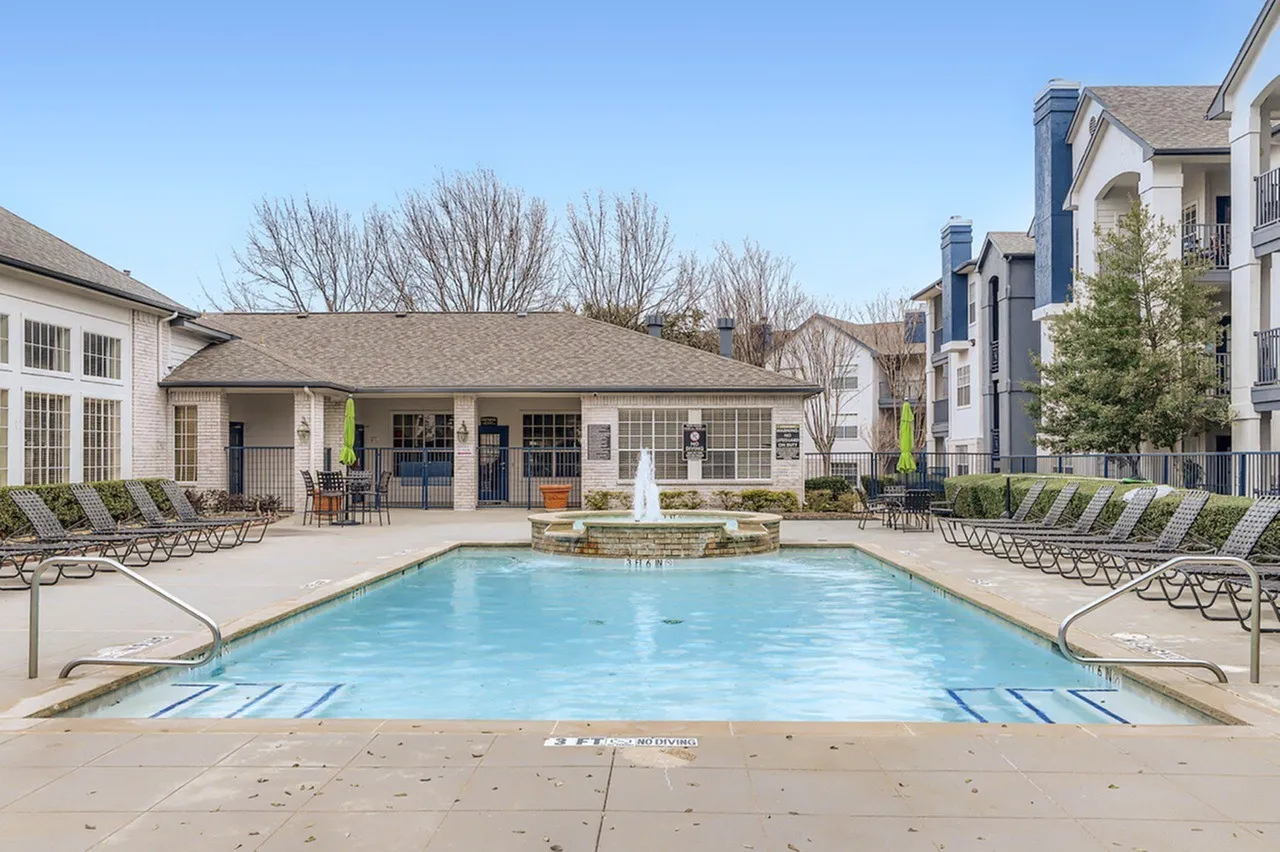 Pool, single-story clubhouse building, porch seating, landscaped courtyard