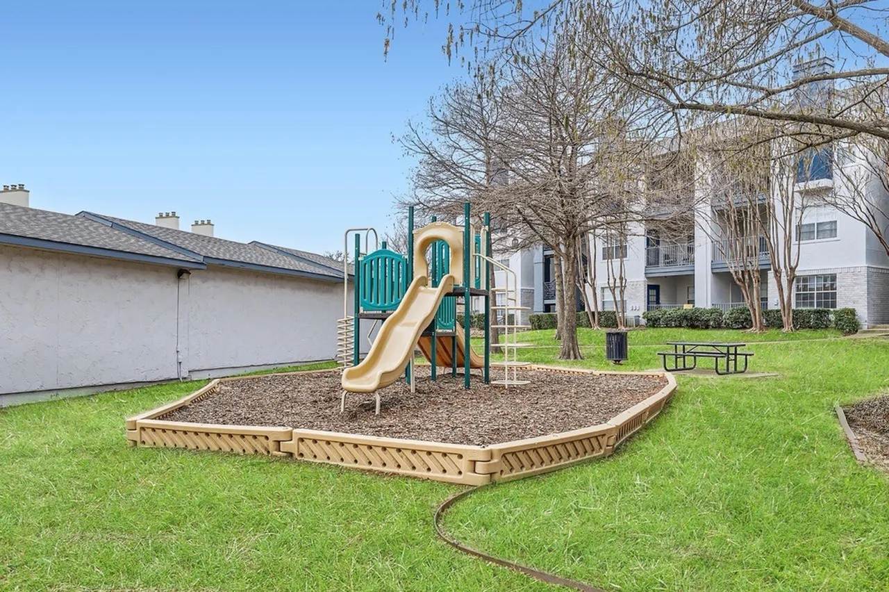 Playground, slide, climbing structure, mulch surface, landscaped lawn