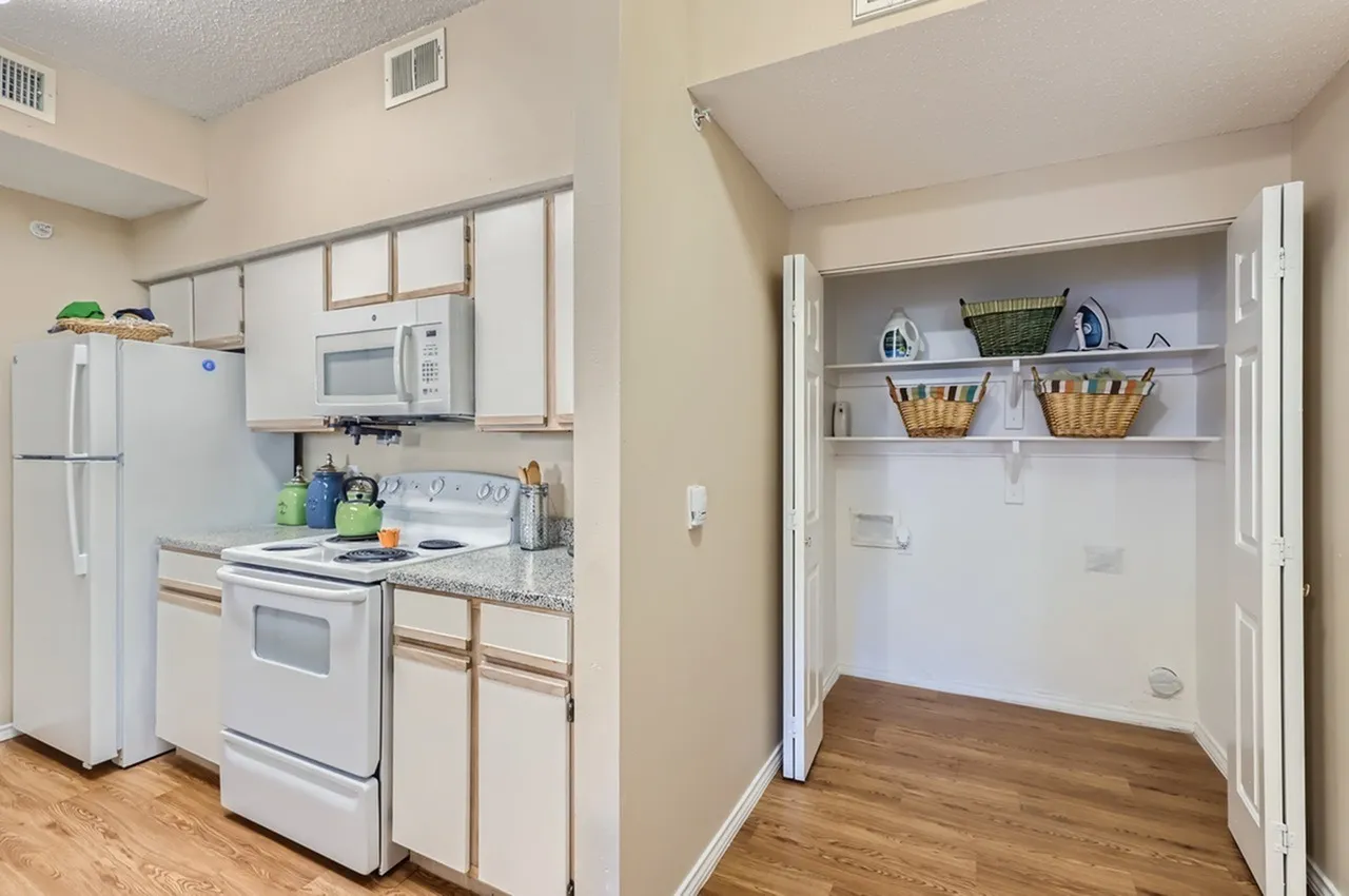 Kitchen, open shelving, white appliances, wood-style plank flooring