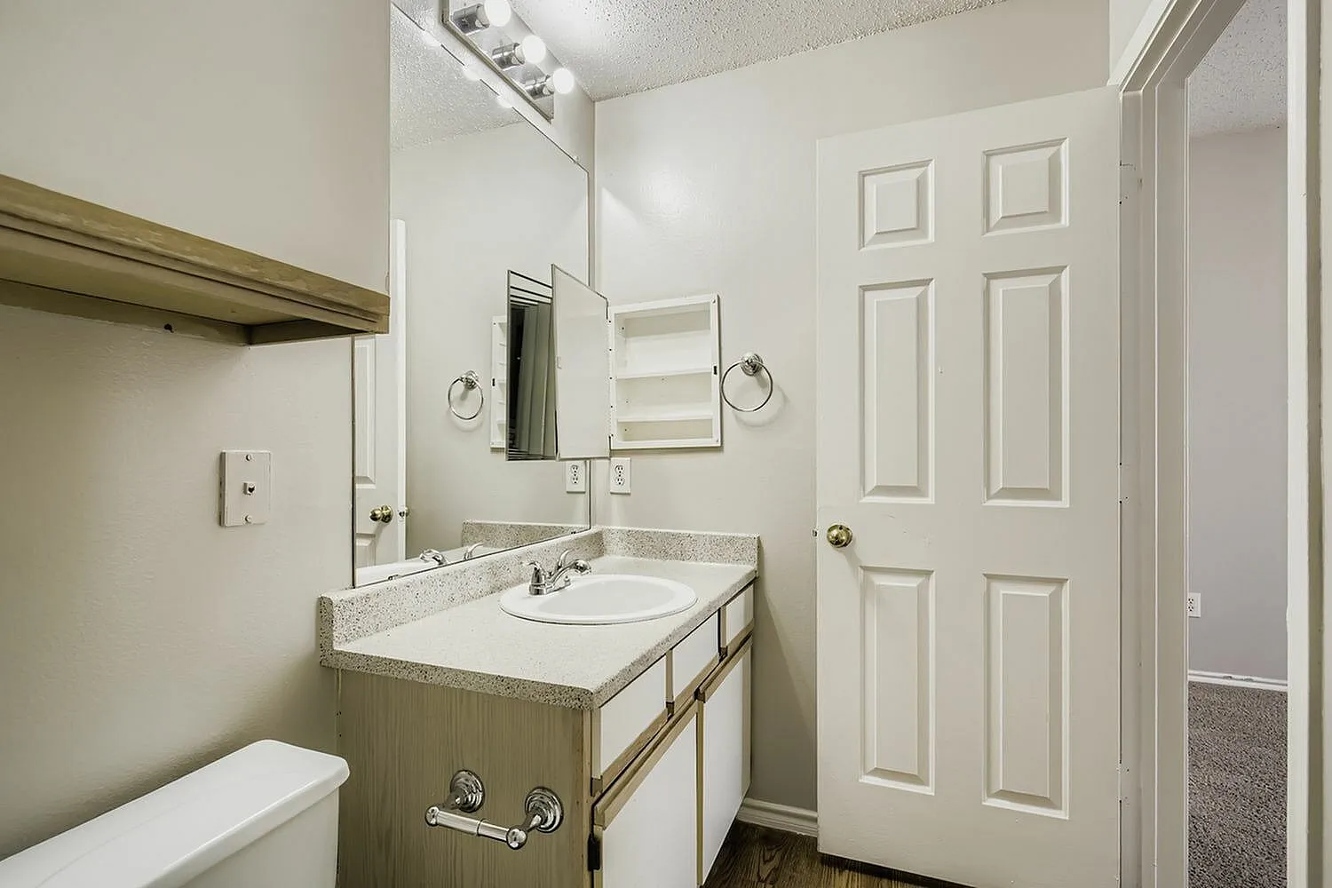 Bathroom vanity, speckled countertop, medicine cabinet mirror