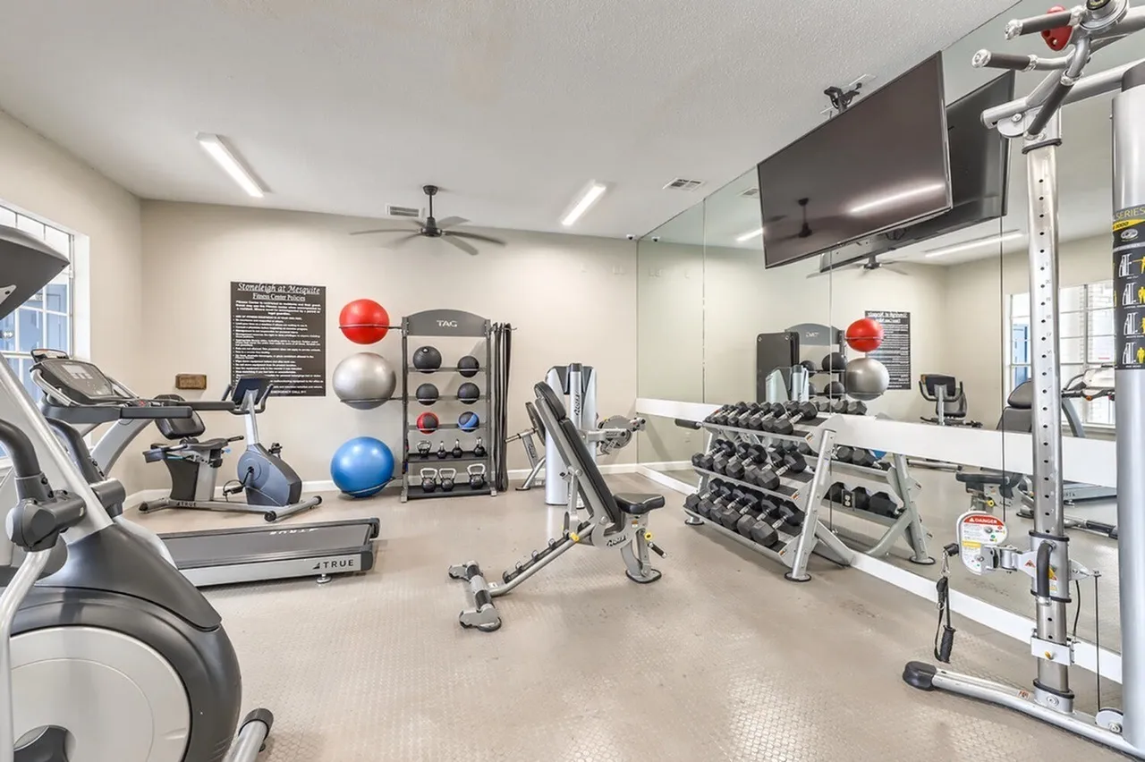 Fitness center, medicine balls, stability ball, weight bench, mirrored wall
