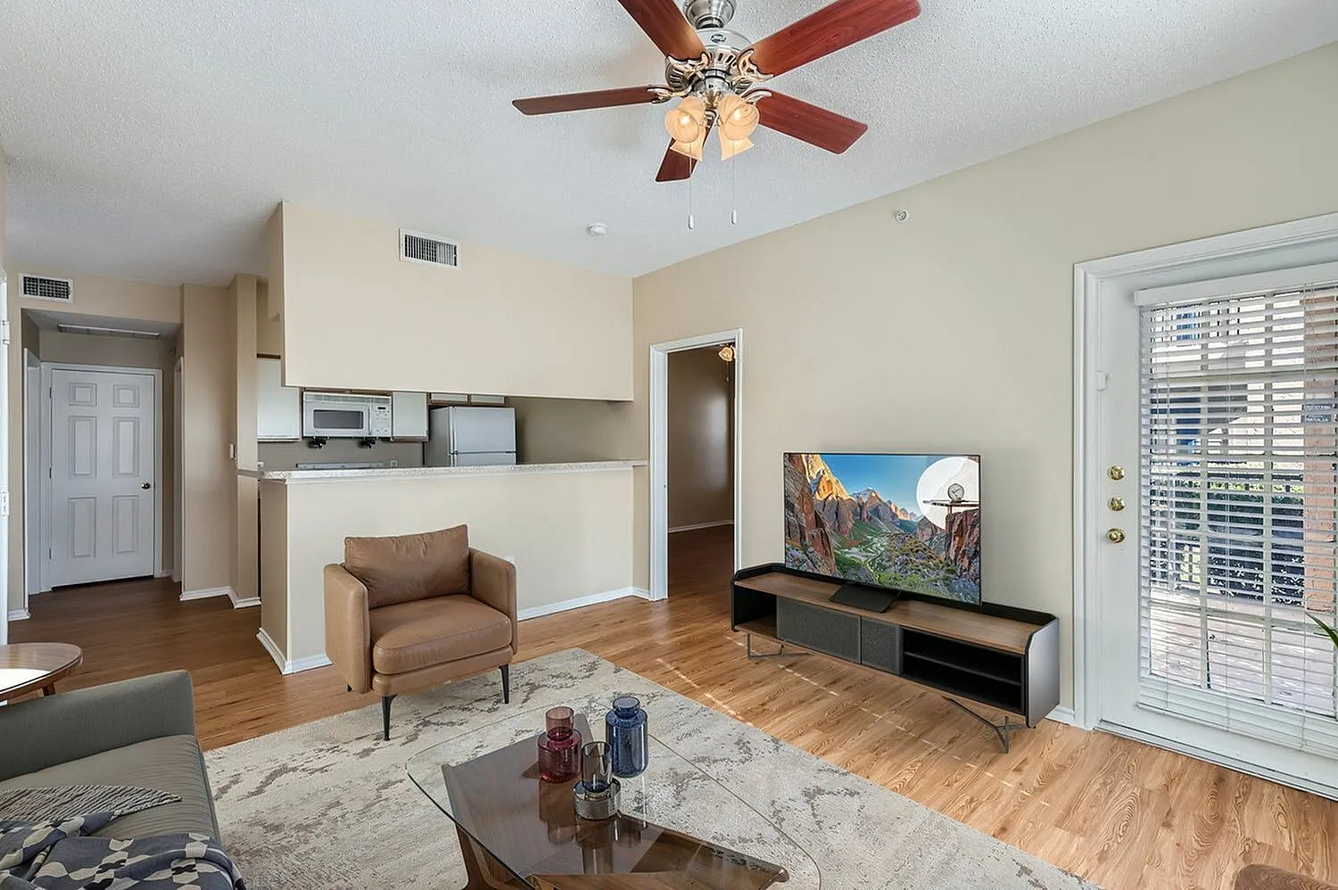 Living room, breakfast bar, wood-style plank flooring, entry hallway