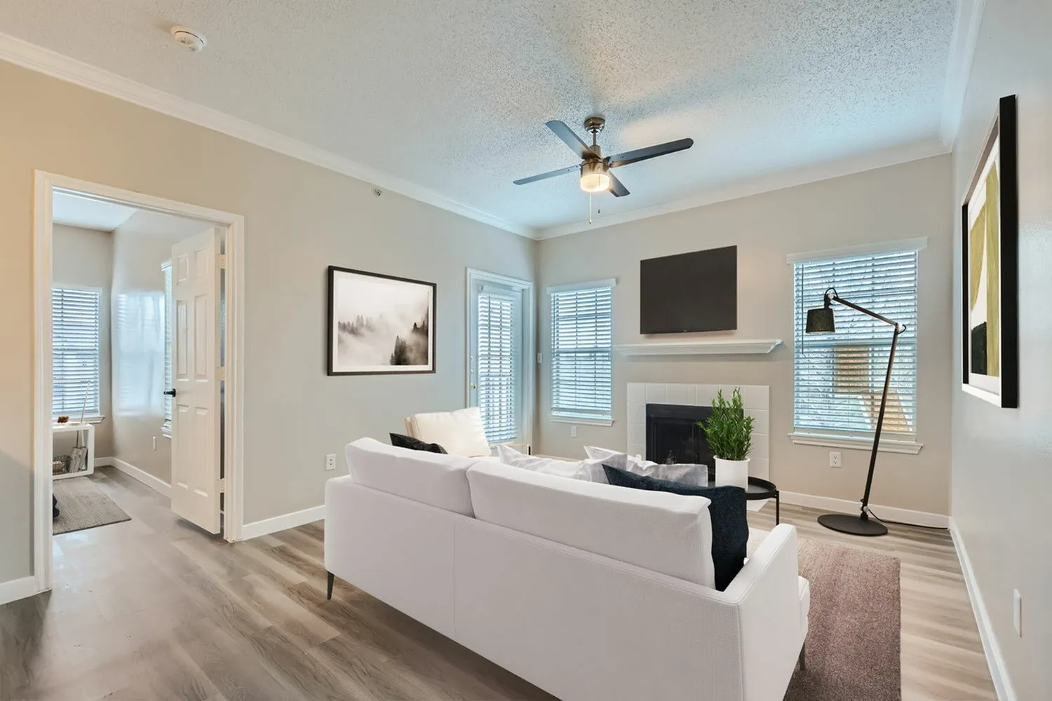 A1 Platinum living room, fireplace, ceiling fan, wood-style plank flooring