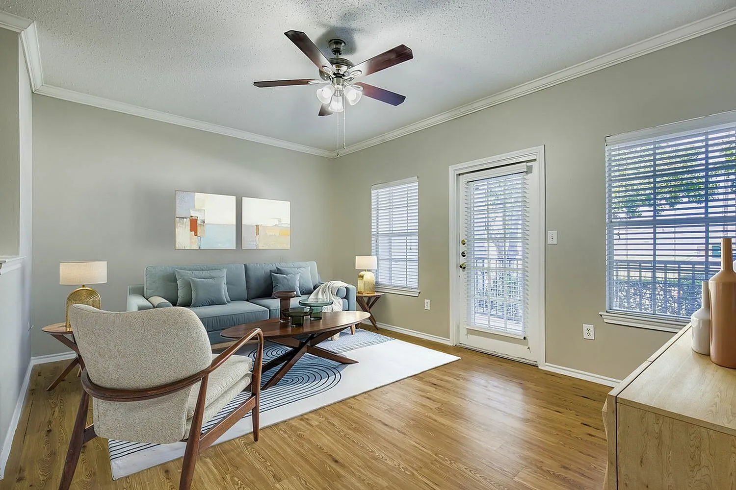 C1 Classic living room, ceiling fan, glass door, wood-style plank flooring