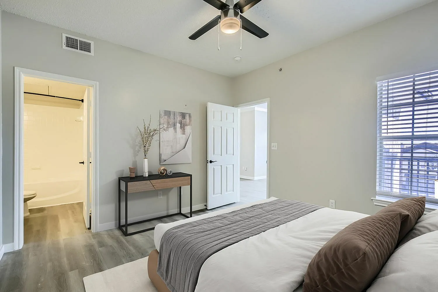 Bedroom, door to ensuite bathroom, wood-style plank flooring