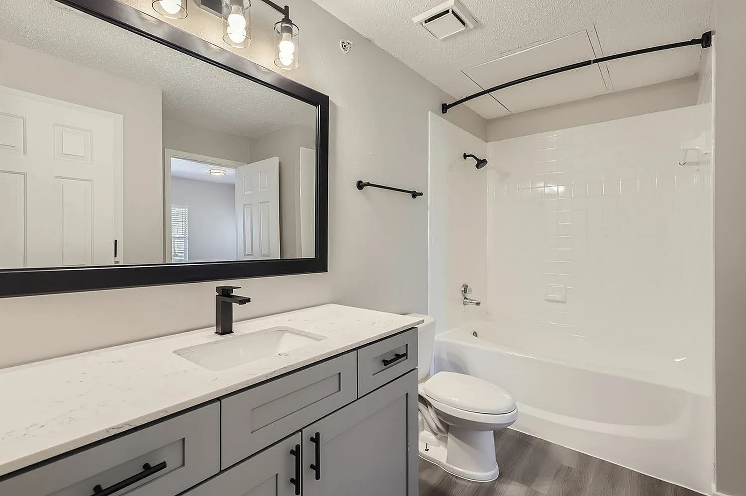 Bathroom vanity, framed mirror, tub shower