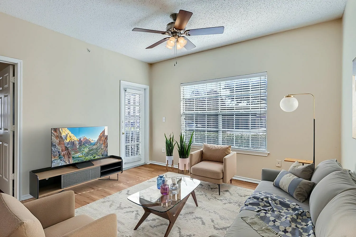 A1 Classic living room, sliding glass door, wood-style plank flooring, window with blinds