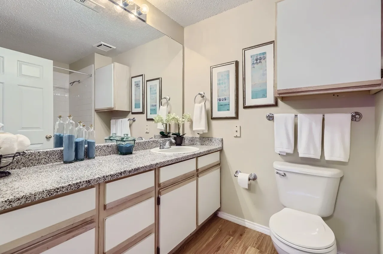 Bathroom vanity, speckled countertop, framed mirror