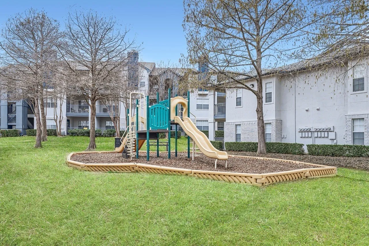 Playground, slide, climbing structure, mulch surface, landscaped lawn