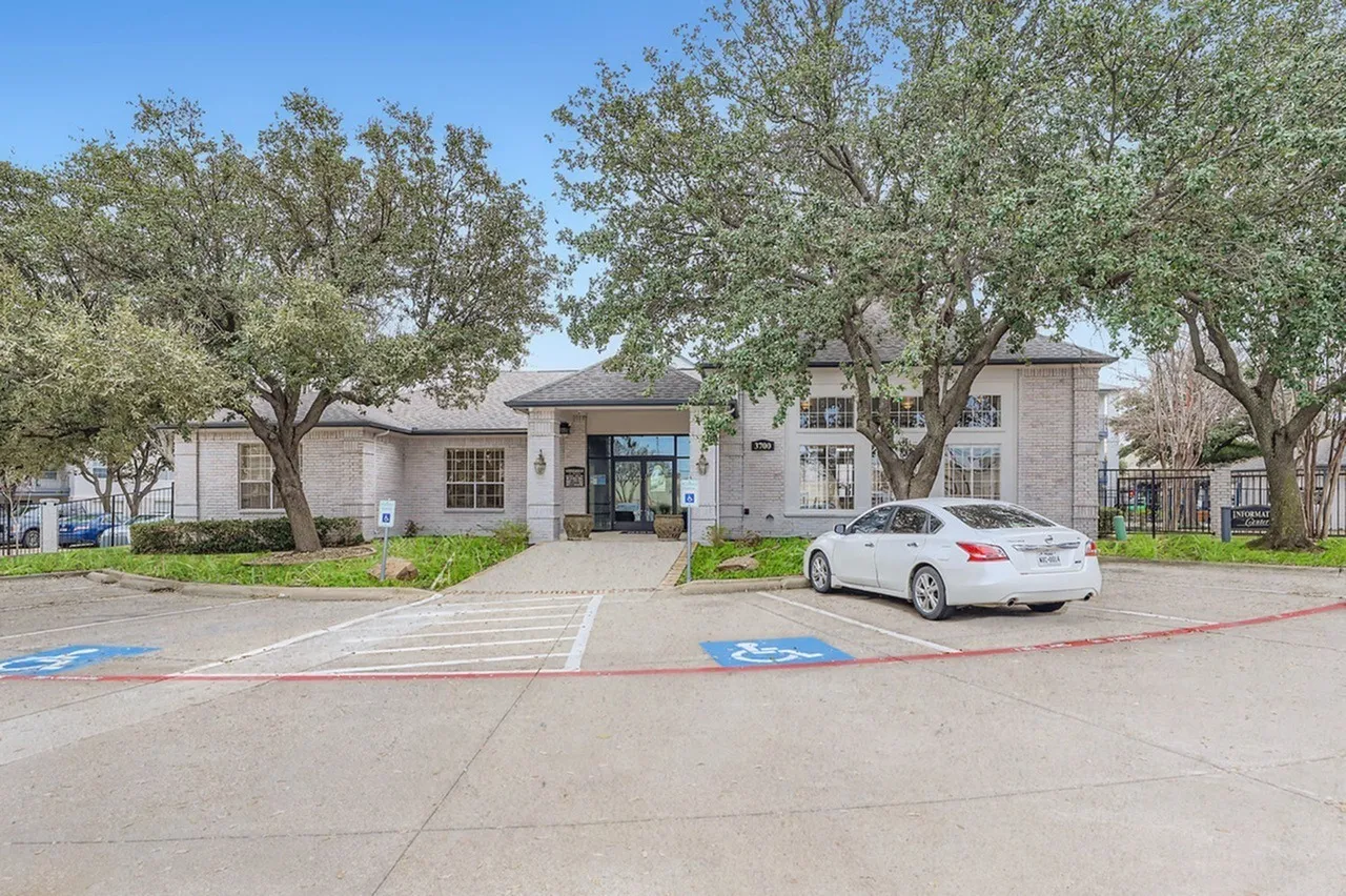 Clubhouse exterior, brick building, parking area, accessible parking space