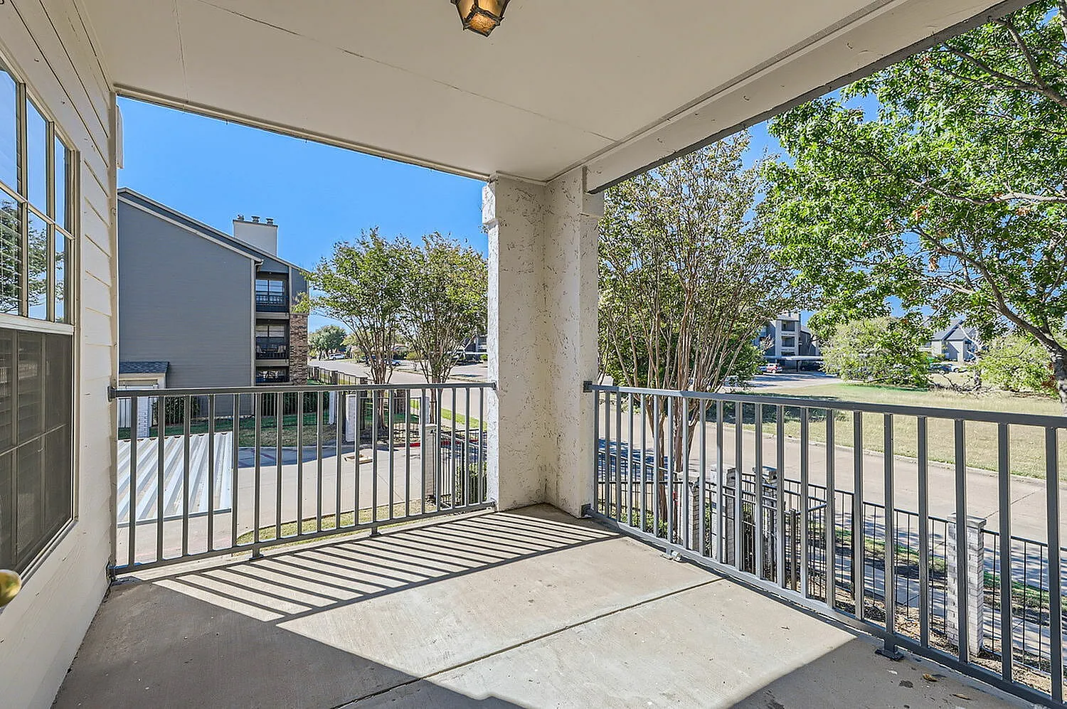 Covered balcony, metal railing, tree views