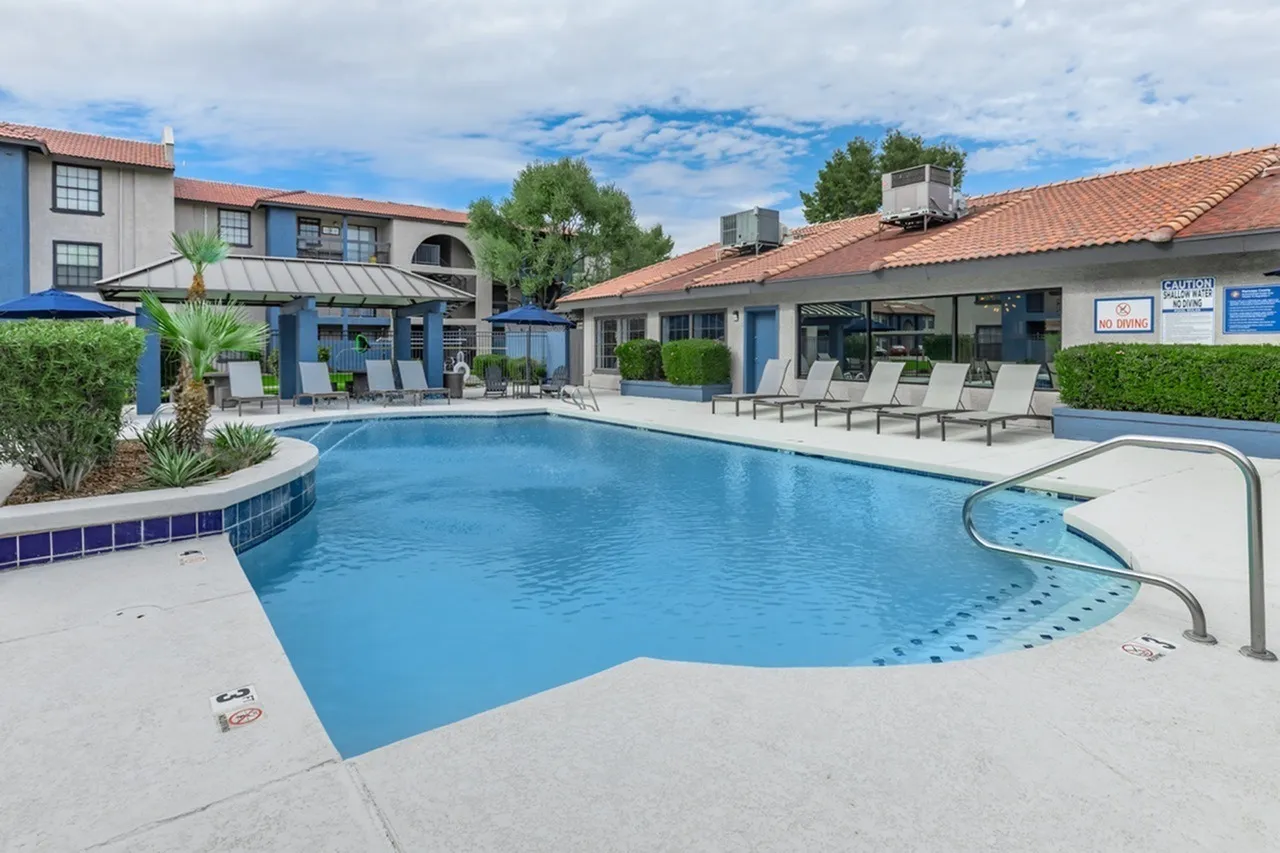 Resort-style swimming pool, lounge seating, spa area, landscaping, community buildings