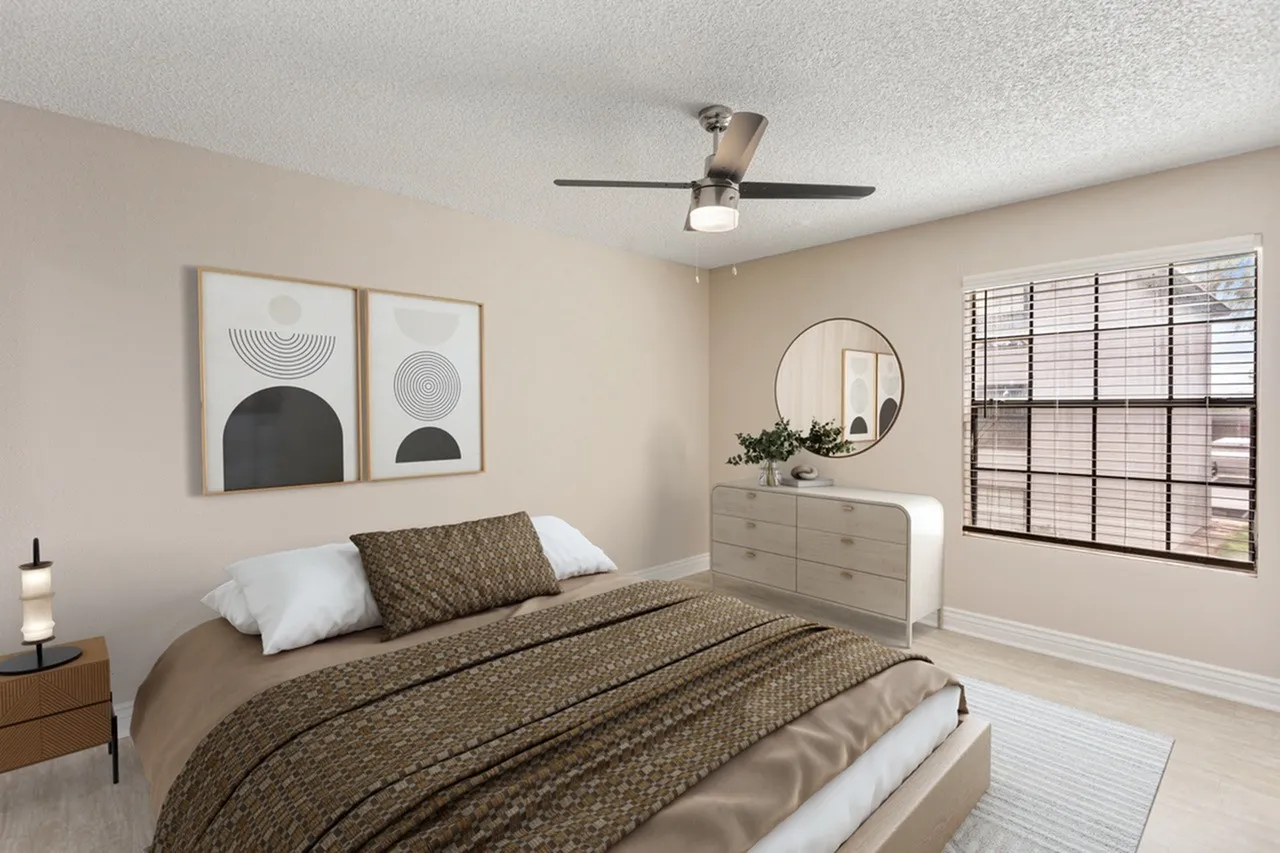 Primary bedroom, ceiling fan, dresser with round mirror, geometric wall art