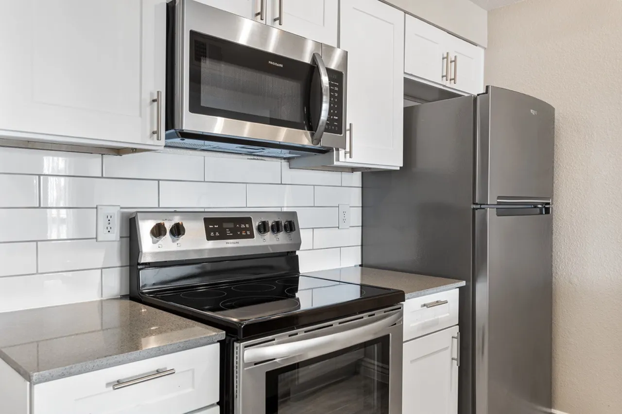 Kitchen, white shaker cabinetry, quartz countertops, stainless steel appliances, subway tile backsplash