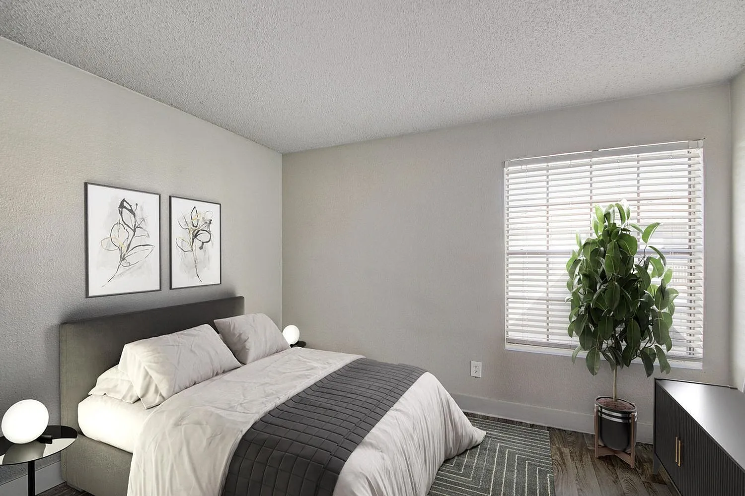 Bedroom, gray upholstered headboard, wood-style plank flooring, plantation shutters, framed botanical art