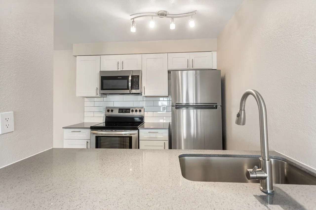 Kitchen, quartz countertops, white shaker cabinetry, stainless appliances, subway tile backsplash
