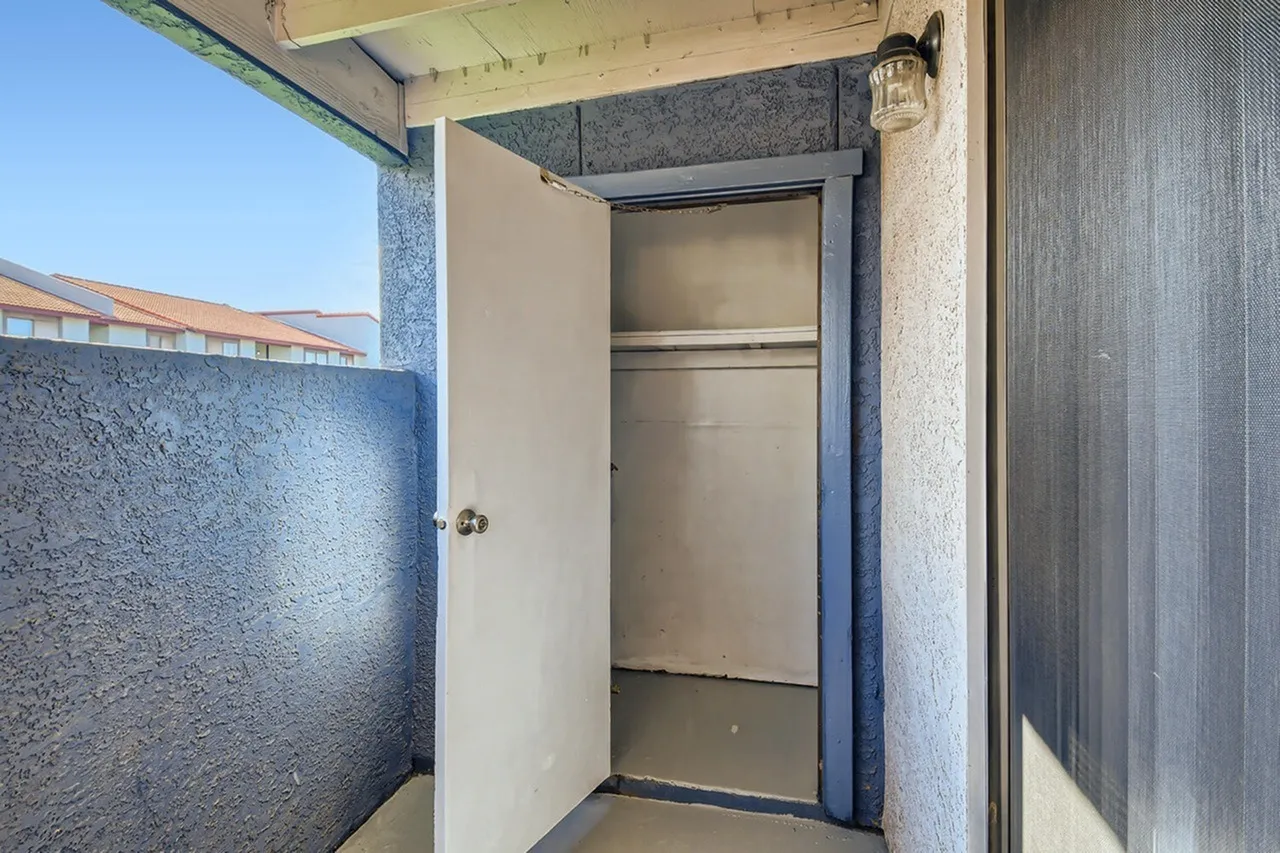 Closet, open door, interior shelving, white frame