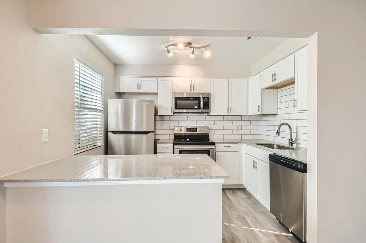 Kitchen, white shaker cabinetry, quartz countertops, stainless appliances, subway tile backsplash