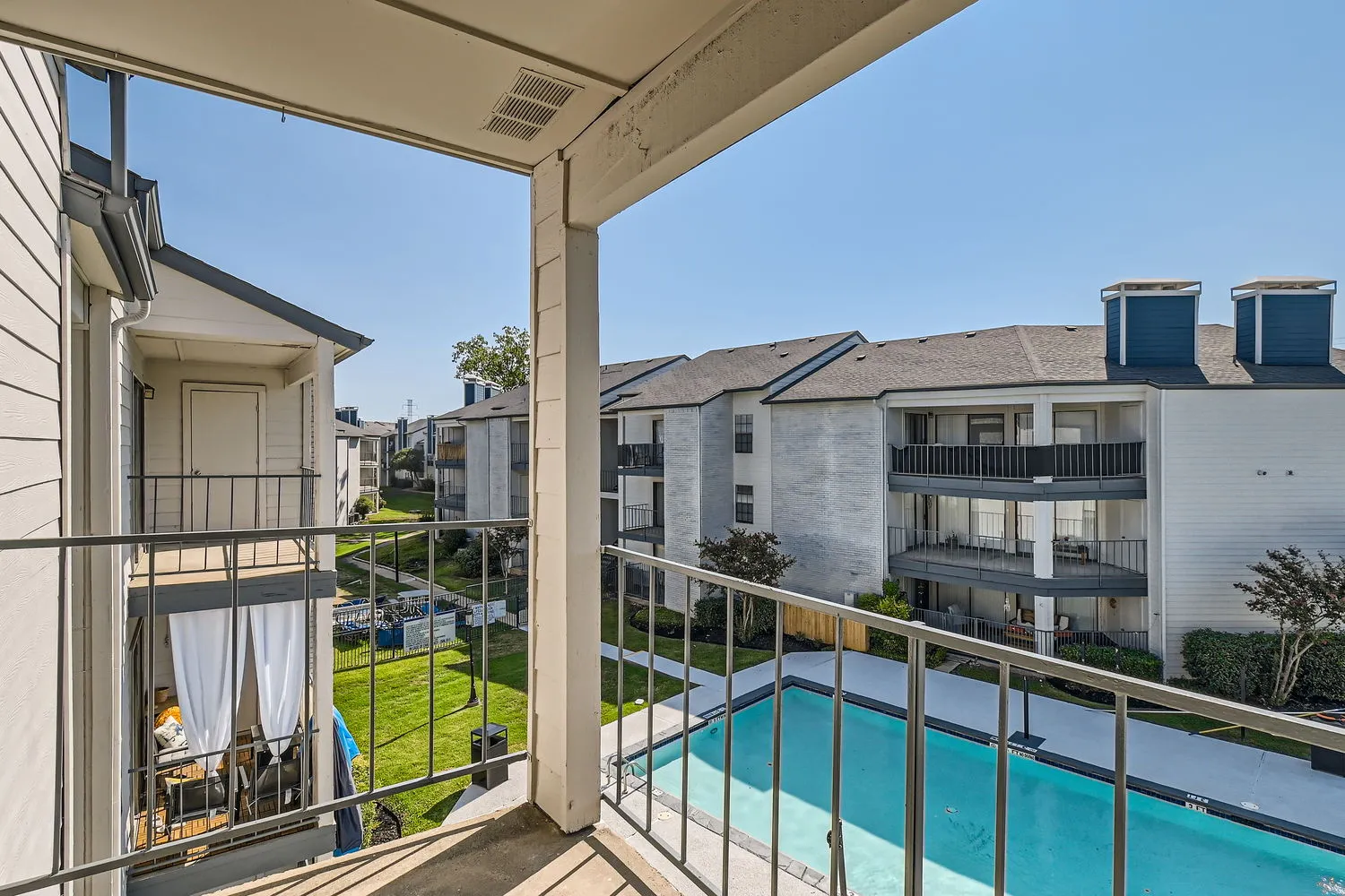 Private balcony, community pool and courtyard view