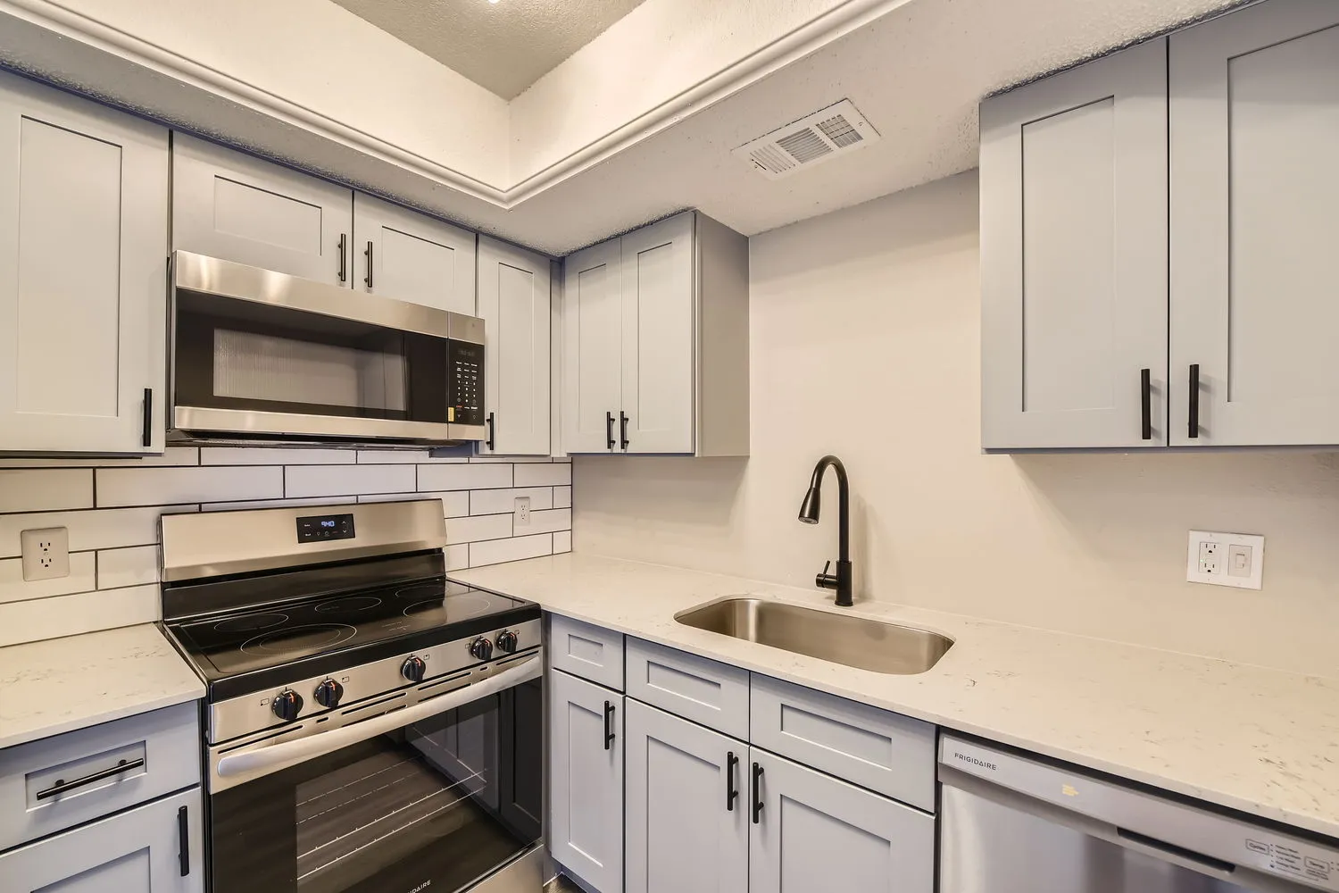 Kitchen, stainless steel appliances, quartz countertops, subway tile backsplash