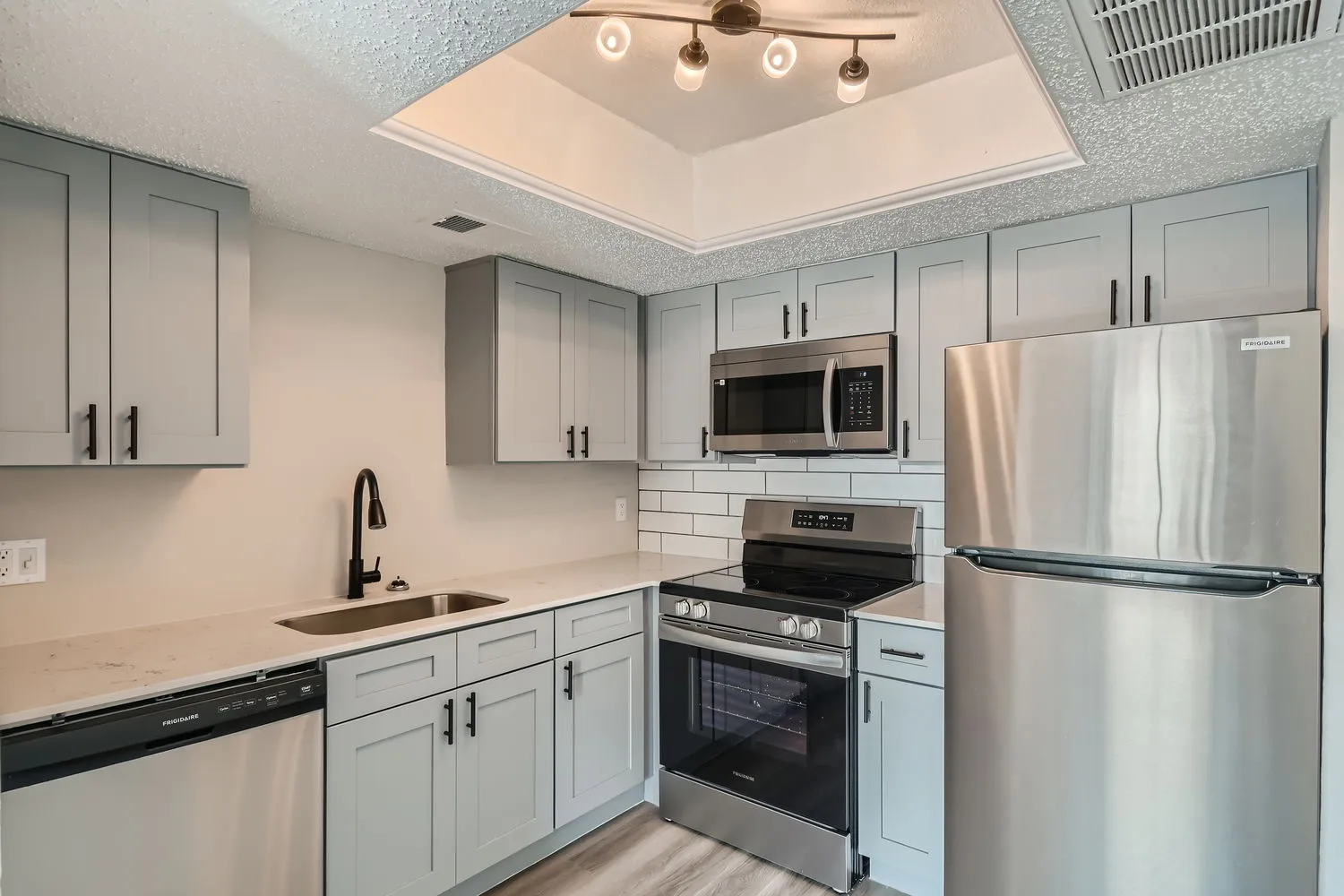 Kitchen, stainless steel appliances, gray shaker cabinets, subway tile backsplash
