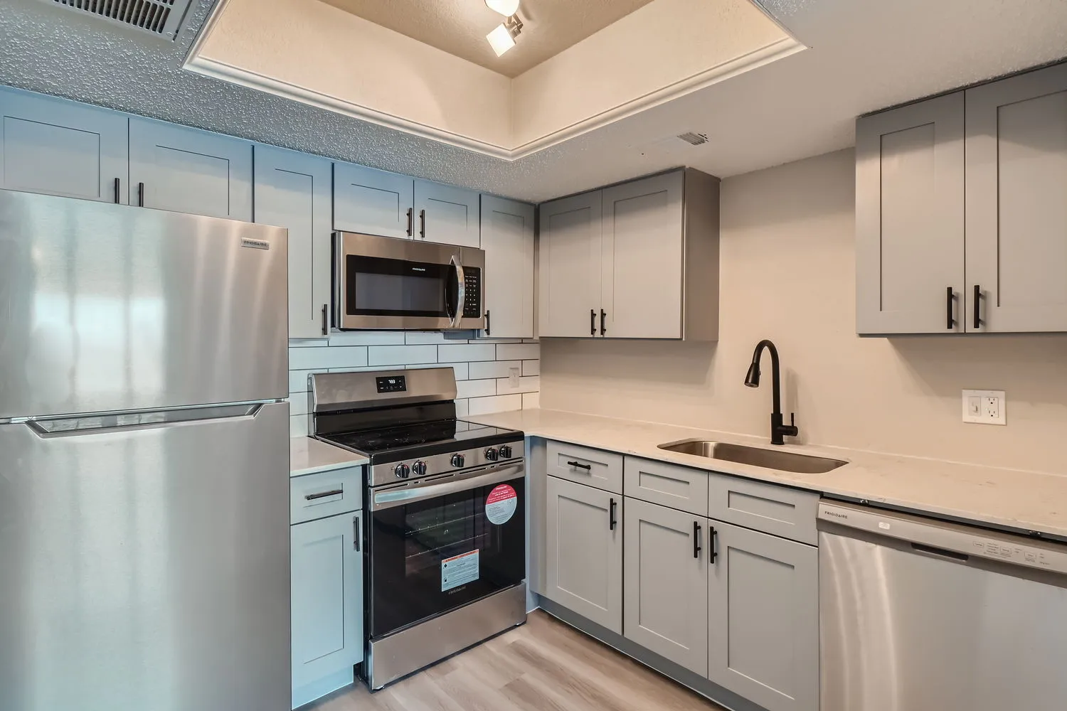 Kitchen, stainless steel appliances, gray shaker cabinets, subway tile backsplash