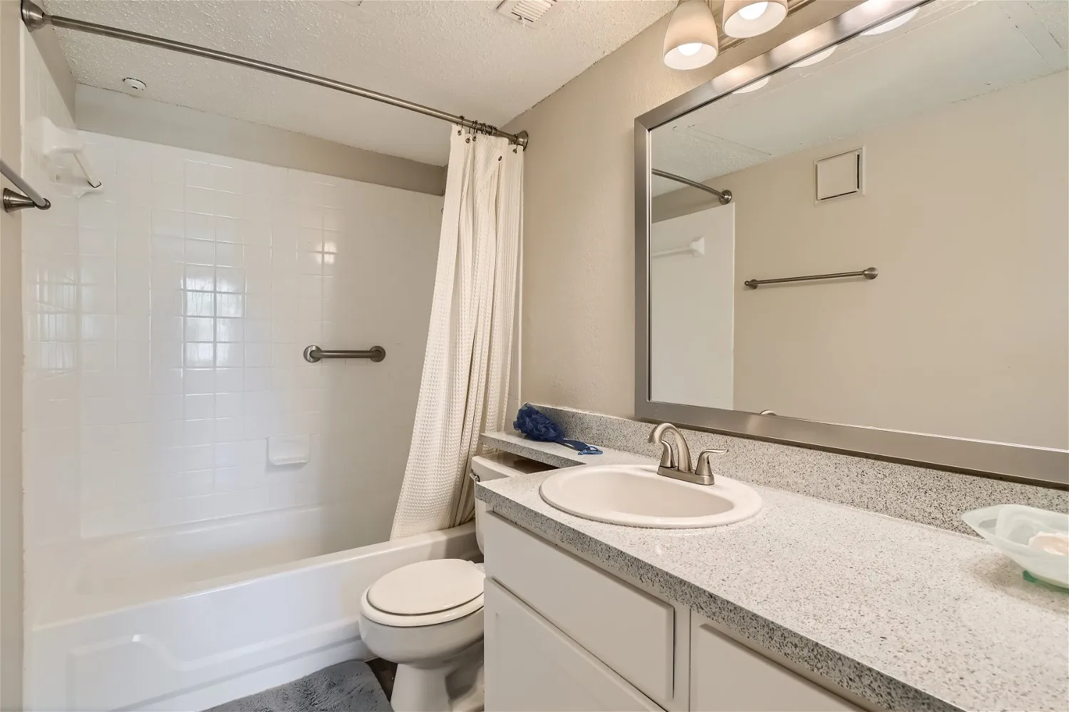 Primary bathroom vanity, tub and shower, framed mirror