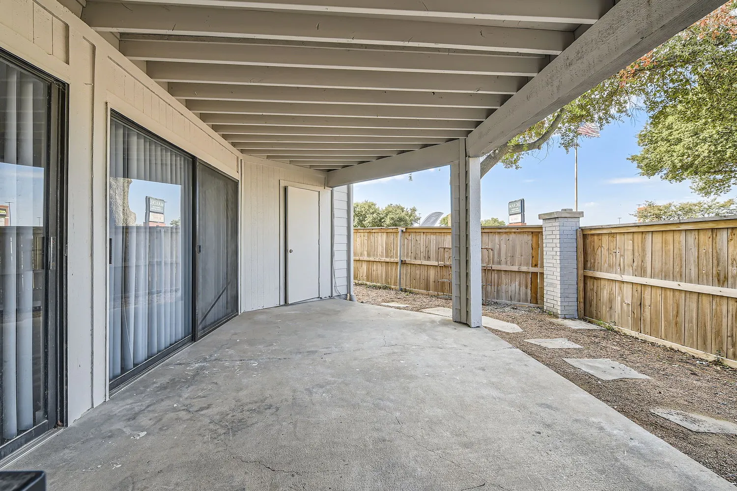 Private patio with sliding glass door access and fenced yard