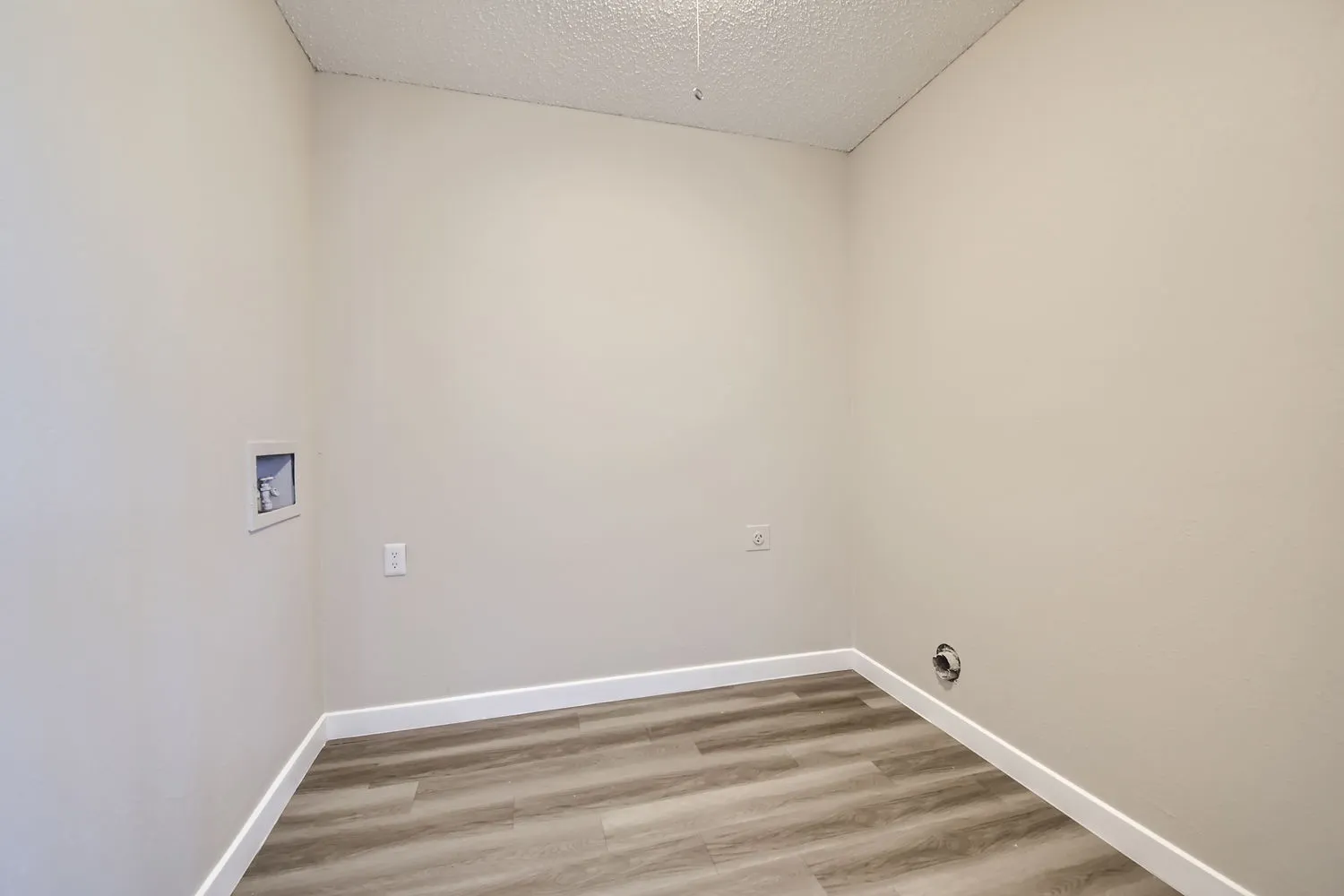 Laundry room with hookups for washer and dryer, wood-style plank flooring