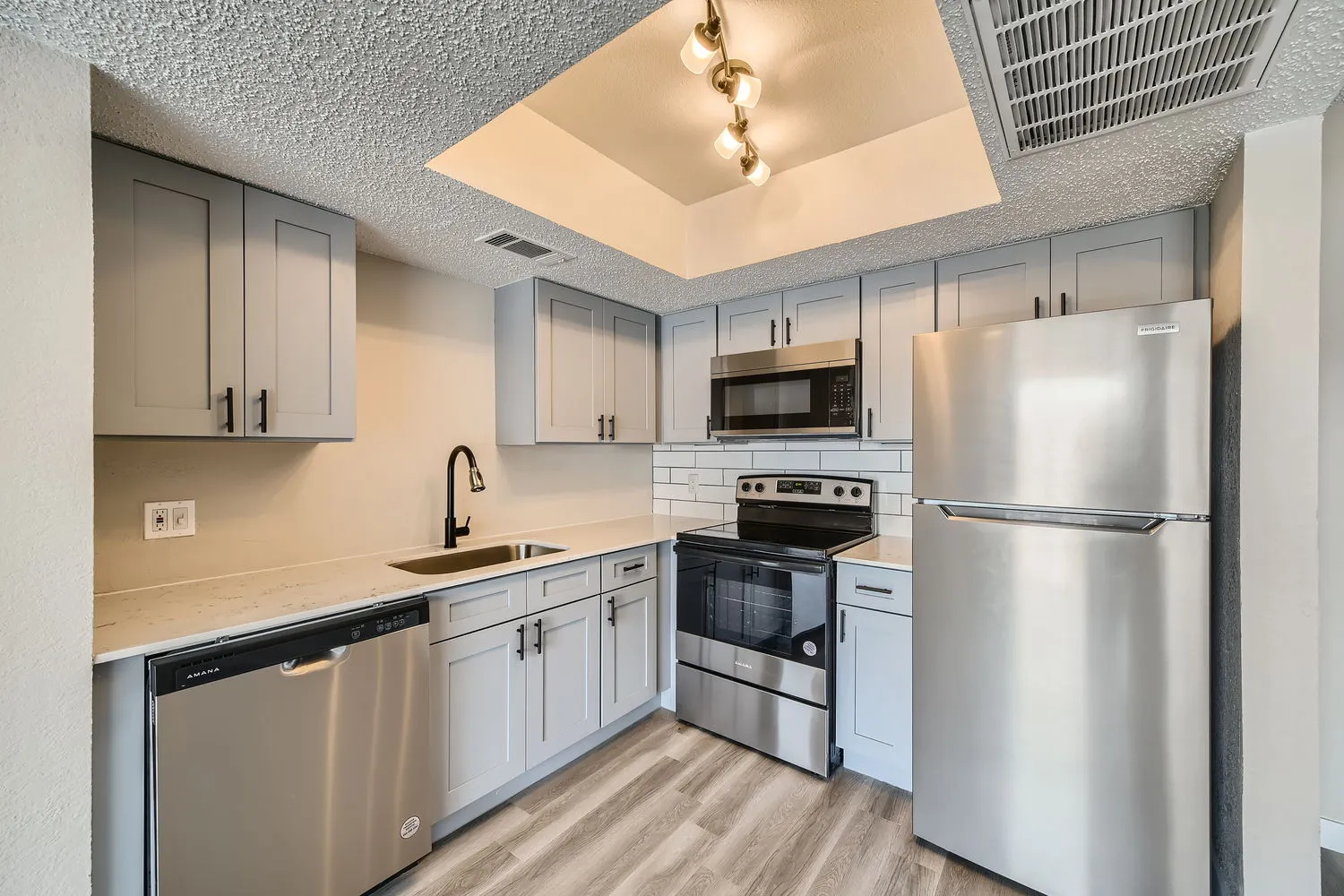 Kitchen, stainless steel appliances, gray shaker cabinets, subway tile backsplash