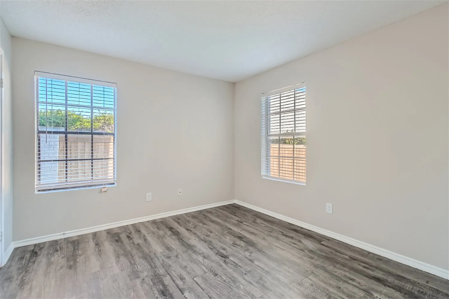 Bedroom, wood-style plank flooring, dual windows