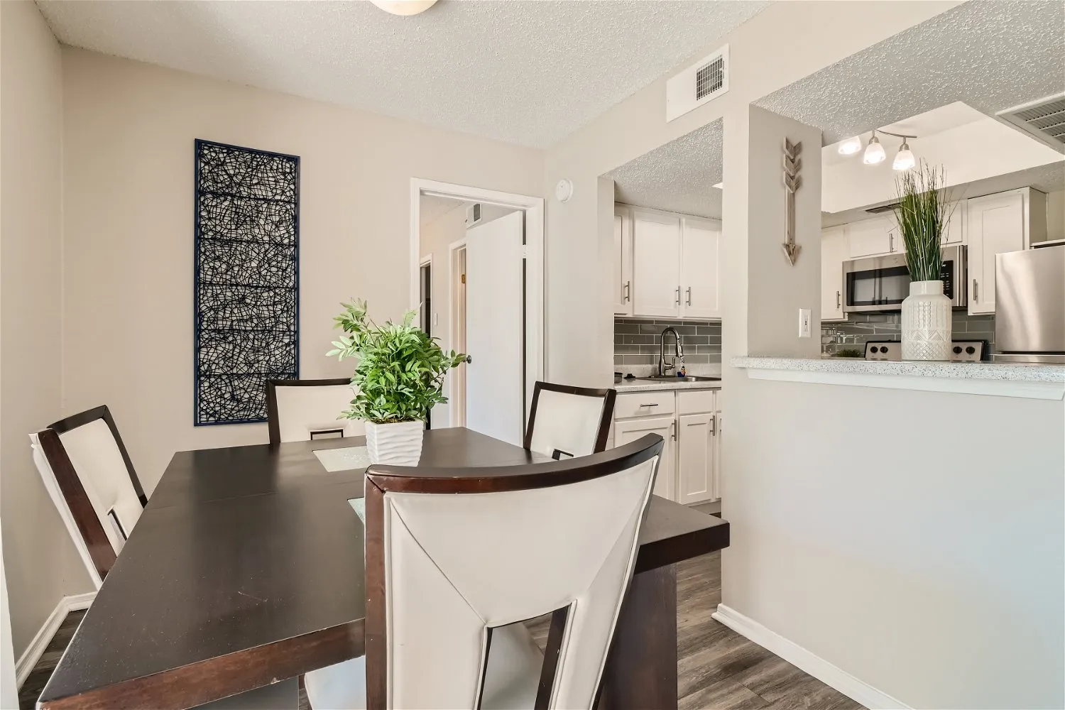 Dining area open to kitchen, subway tile backsplash