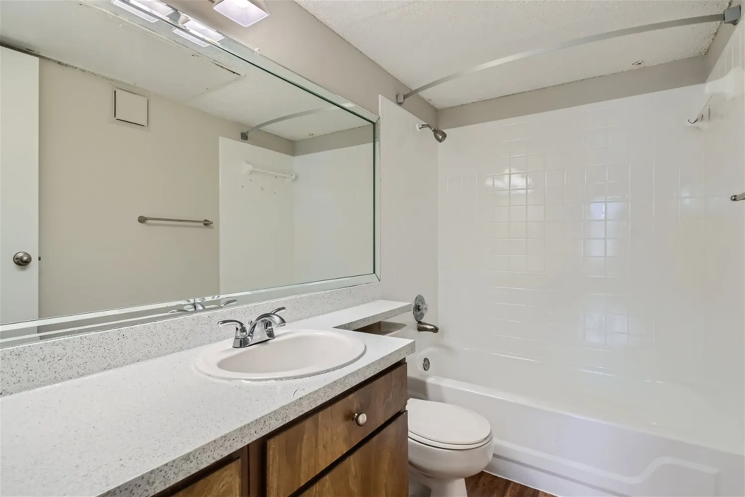 Bathroom vanity, tub and shower combo, framed mirror