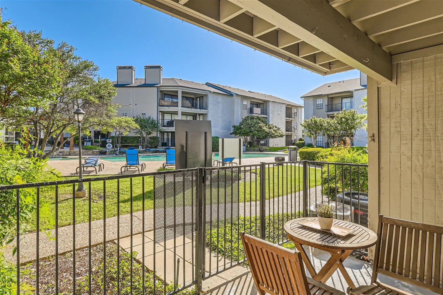 Private patio, community pool and courtyard view