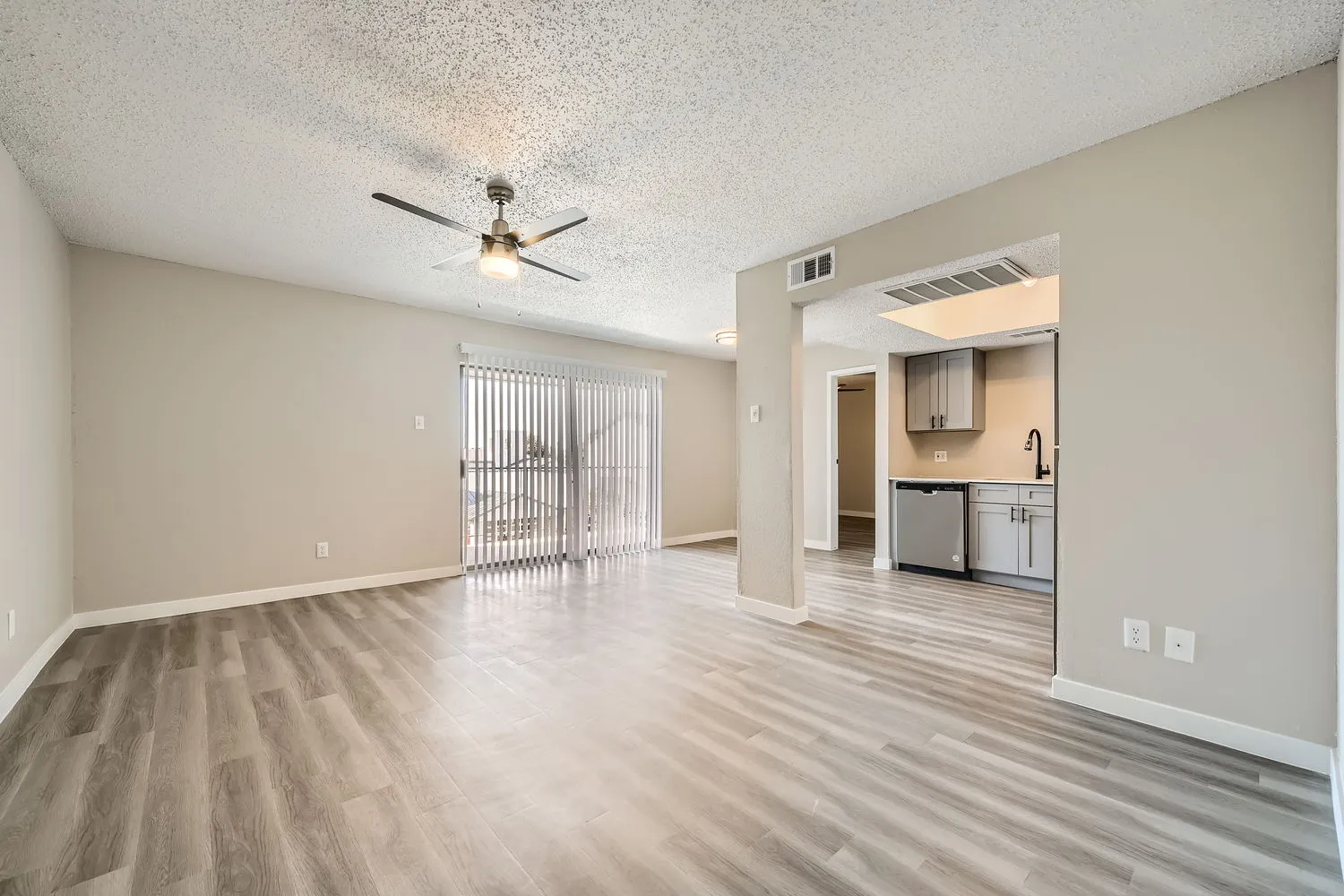 A4 Platinum living room, wood-style plank flooring, ceiling fan, sliding glass door